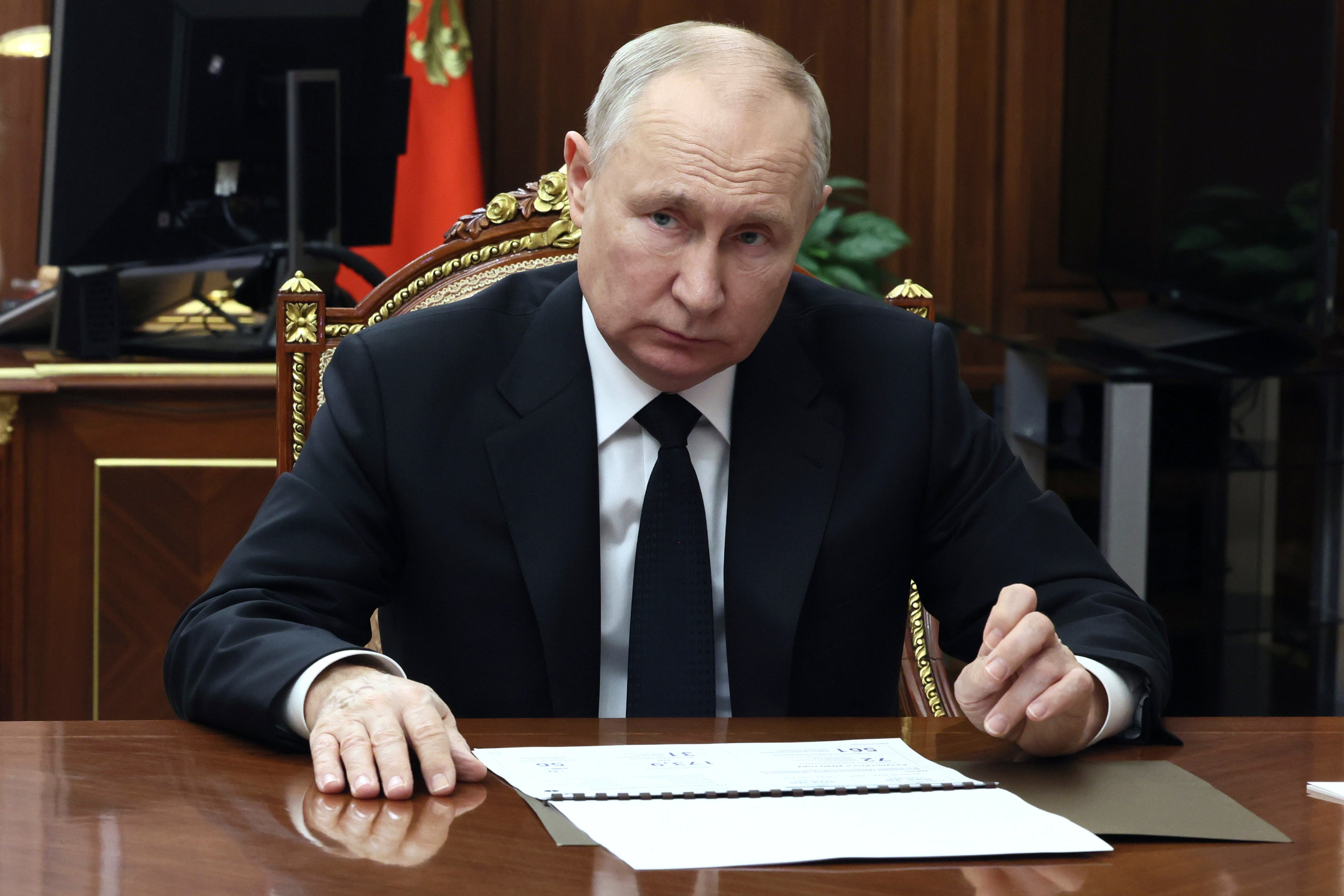 <p>Russian president Vladimir Putin listens to Russian deputy prime minister</p>