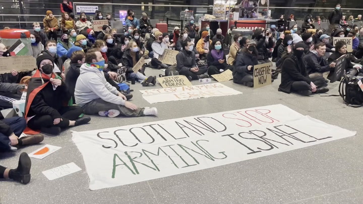 A demonstration for Palestine in Glasgow's train station demands an end to hostilities.