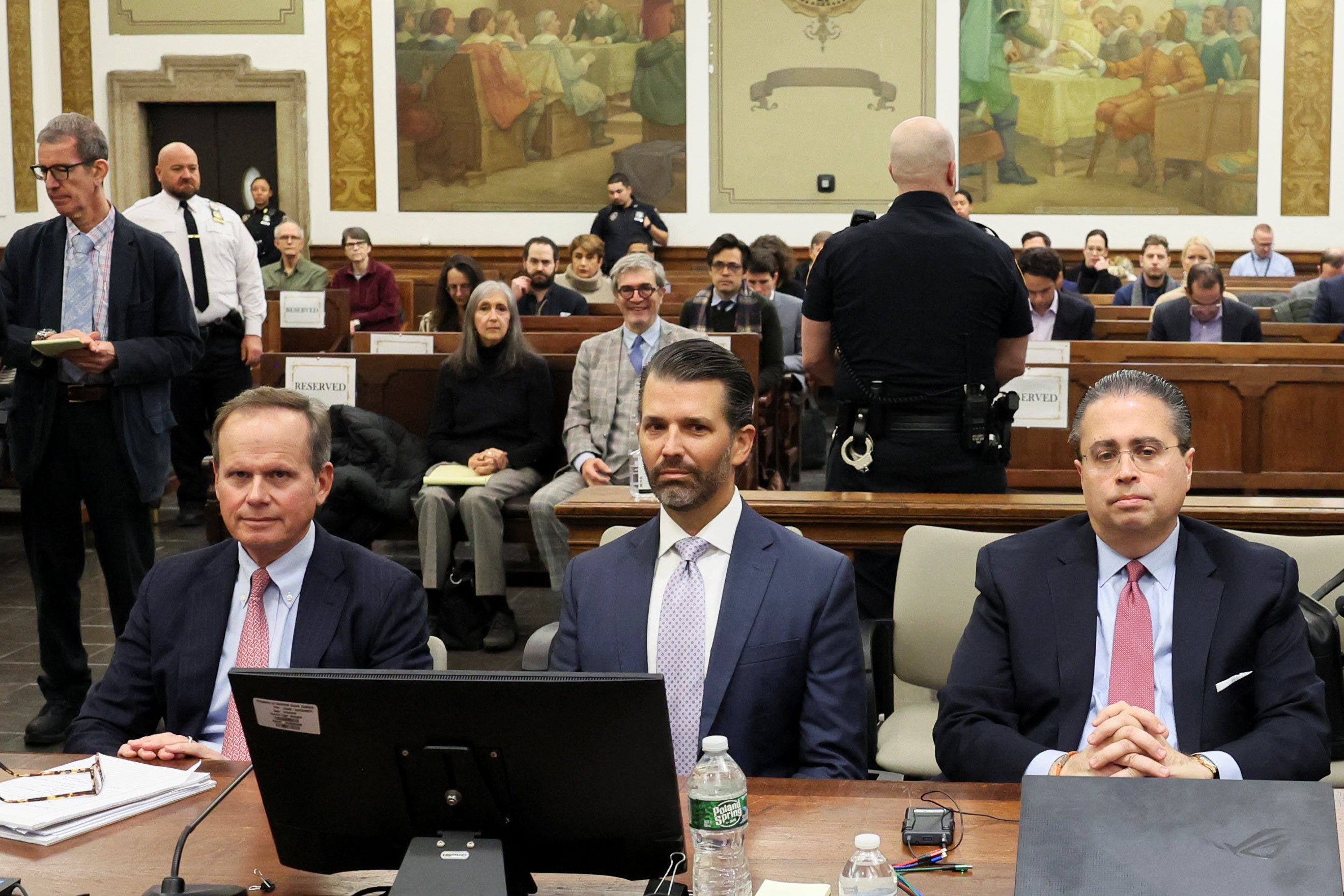 <p>Donald Trump Jr sits with attorneys Christopher Kise, left, and Clifford Robert, right on 13 November. </p>