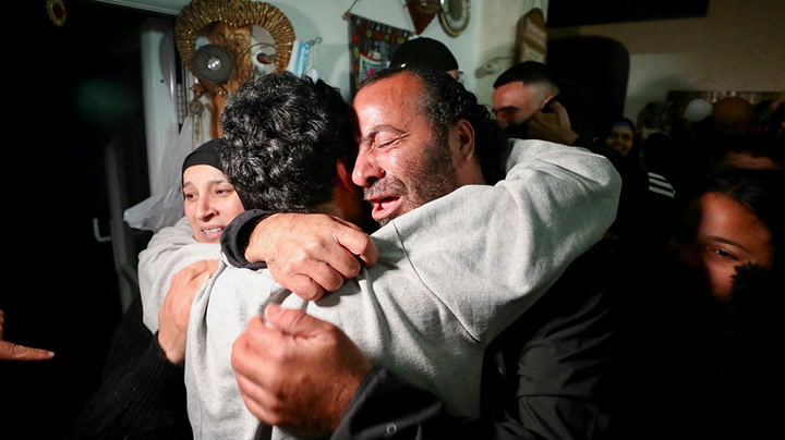 Families celebrate as Palestinians released from prison return to Jerusalem.