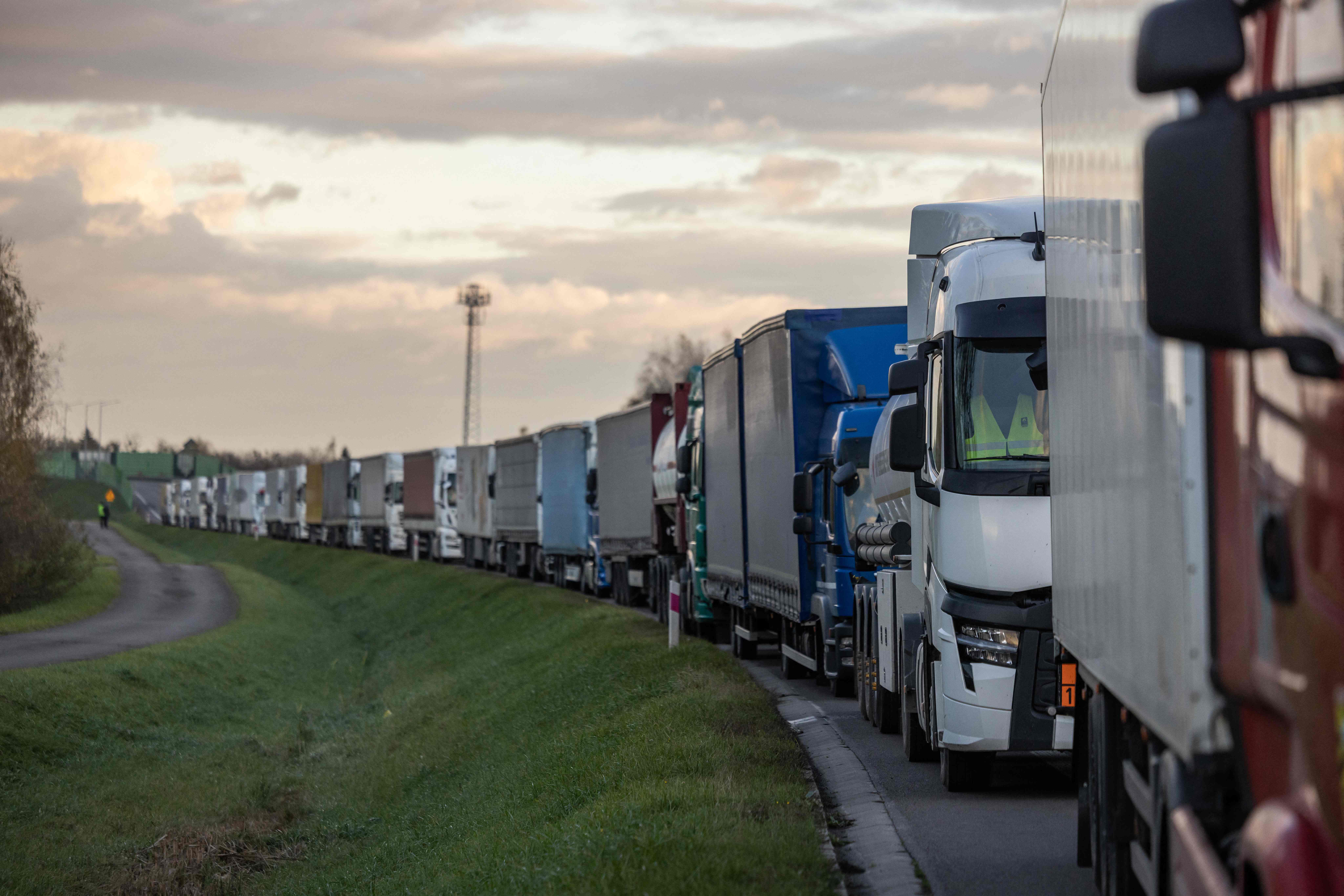 <p>Lorries queue on a motorway as Polish hauliers use their vehicles to block access to the Ukrainian border crossing in Dorohusk</p>