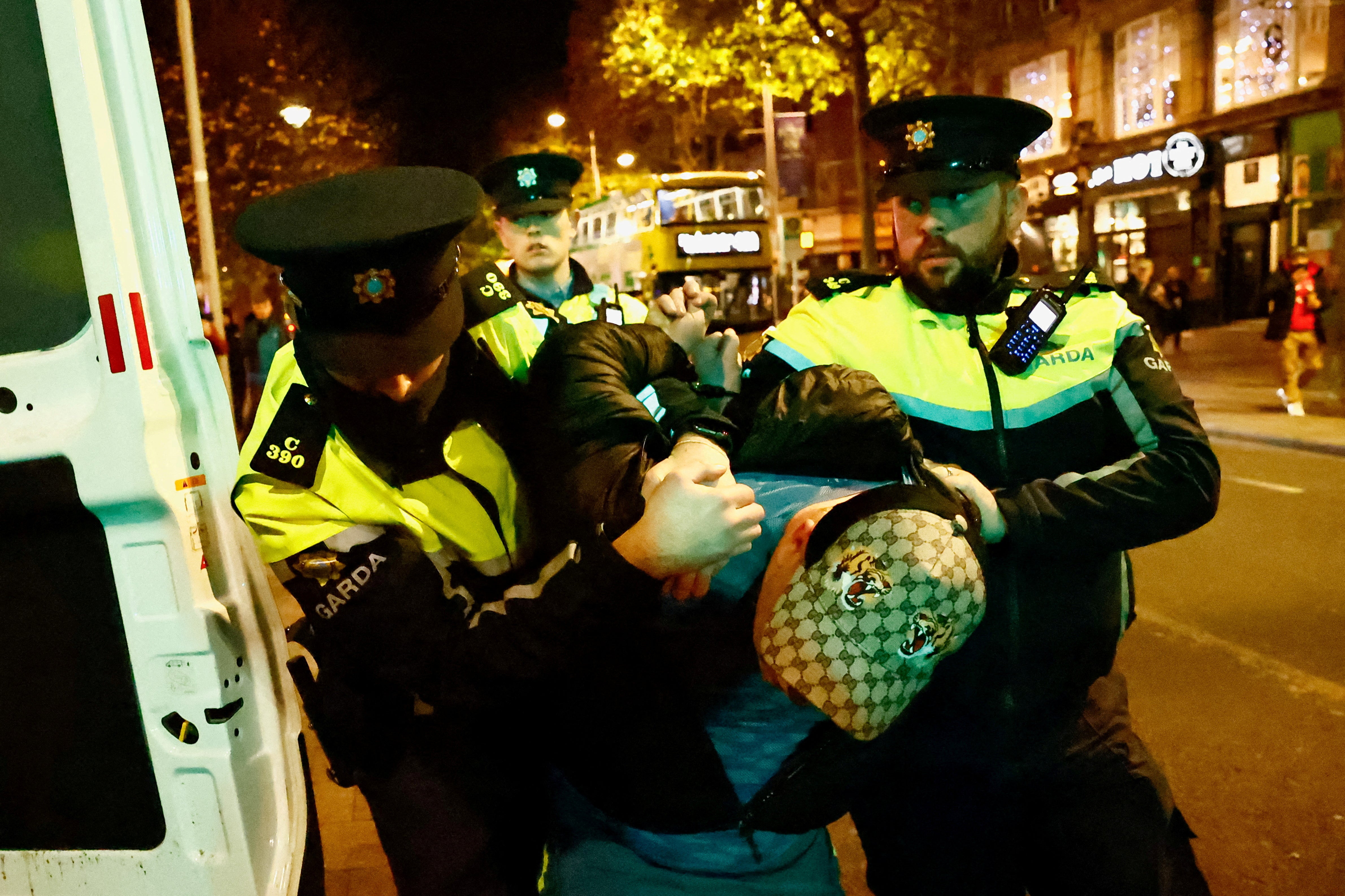 <p>Members of the Garda Public Order Unit detain a man, following the riot in the aftermath of the school stabbing in Dublin </p>