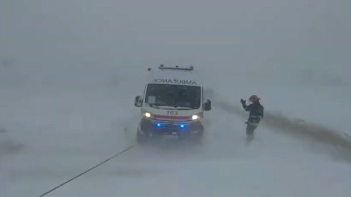 <p>Ukrainian emergency workers tow ambulance from snow as storm kills five</p>