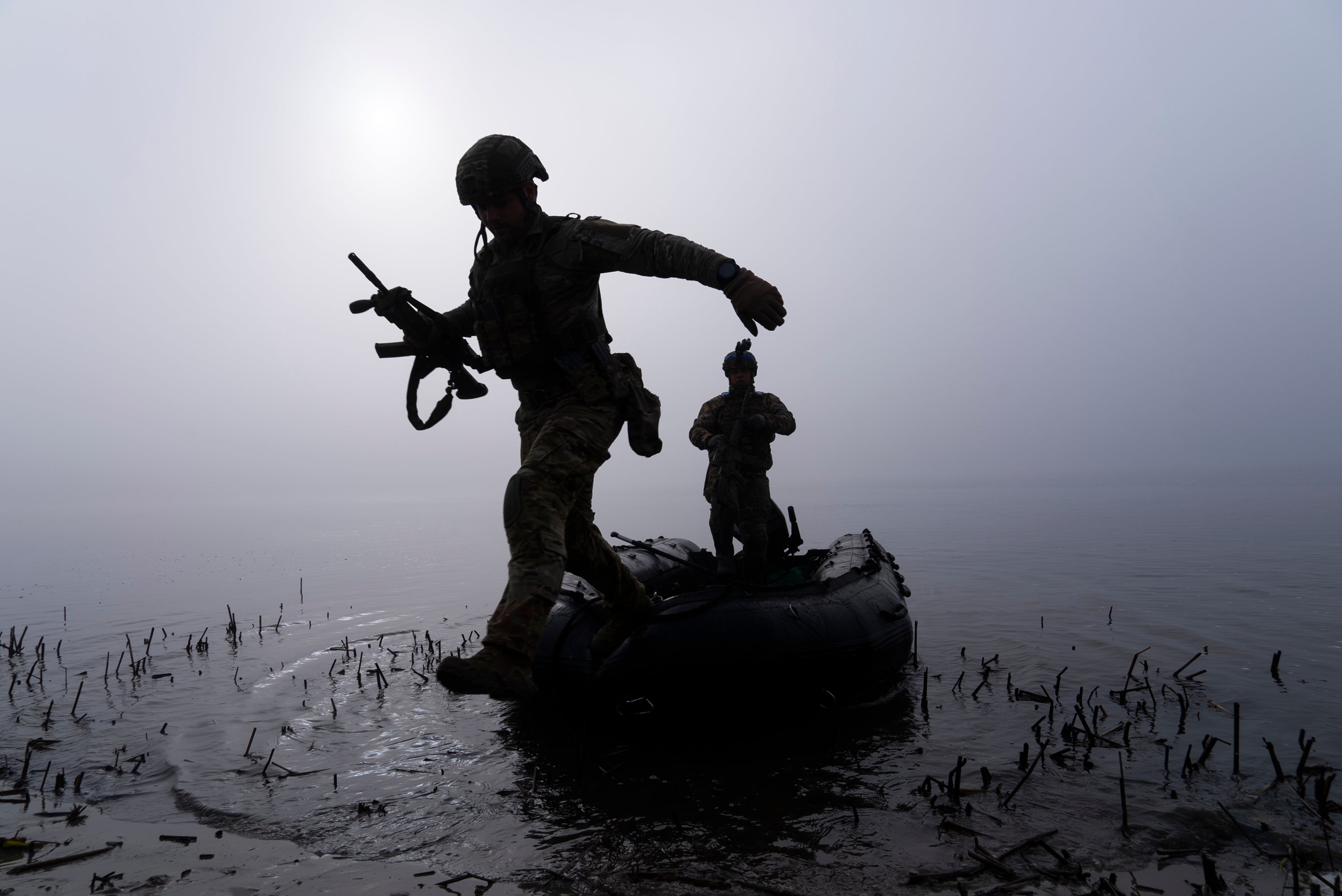 <p>A Ukrainian serviceman jumps out of the boat on the shore of Dnipro river at the frontline near Kherson, Ukraine, Sunday Oct. 15, 2023.</p>