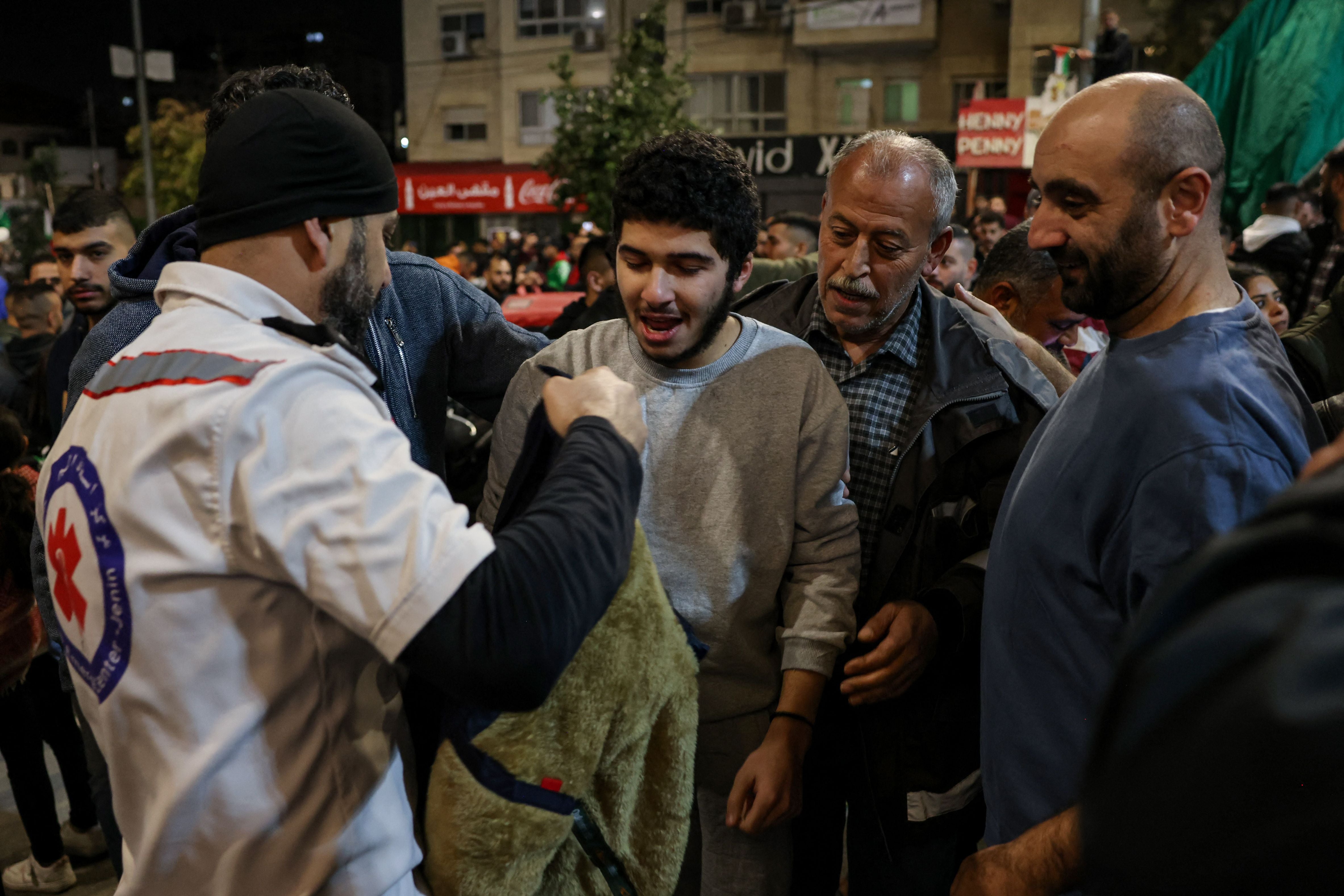 <p>A Palestinian prisoner (C) is welcomed in Ramallah, West Bank, by relatives after detainees were released from Israeli jails</p>