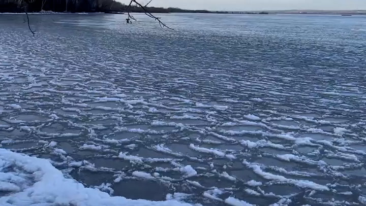 An uncommon occurrence of 'pancake' ice has formed over a Wisconsin lake due to a decrease in temperatures.