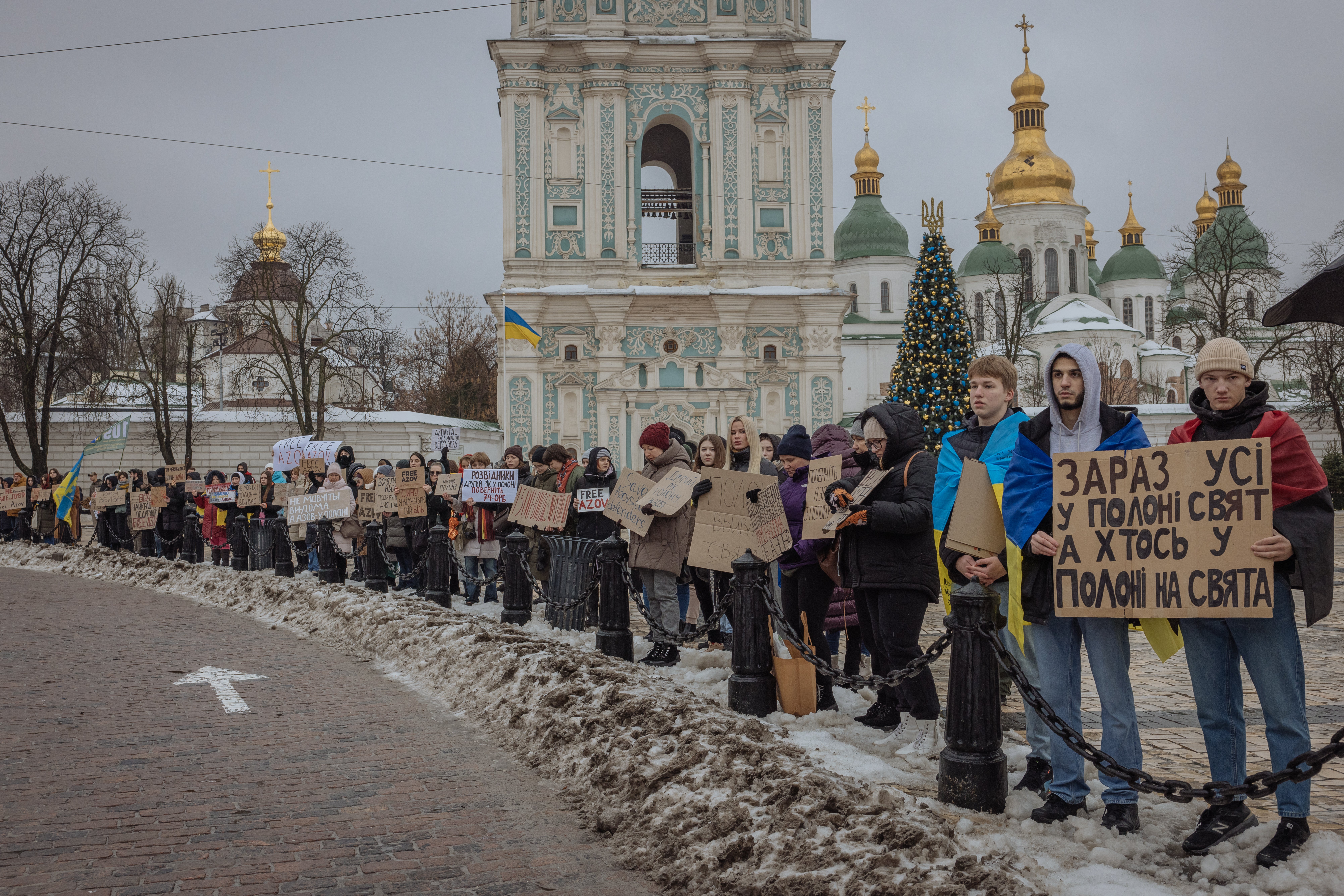 <p>Relatives and friends of Ukrainian prisoners of war hold placards</p>