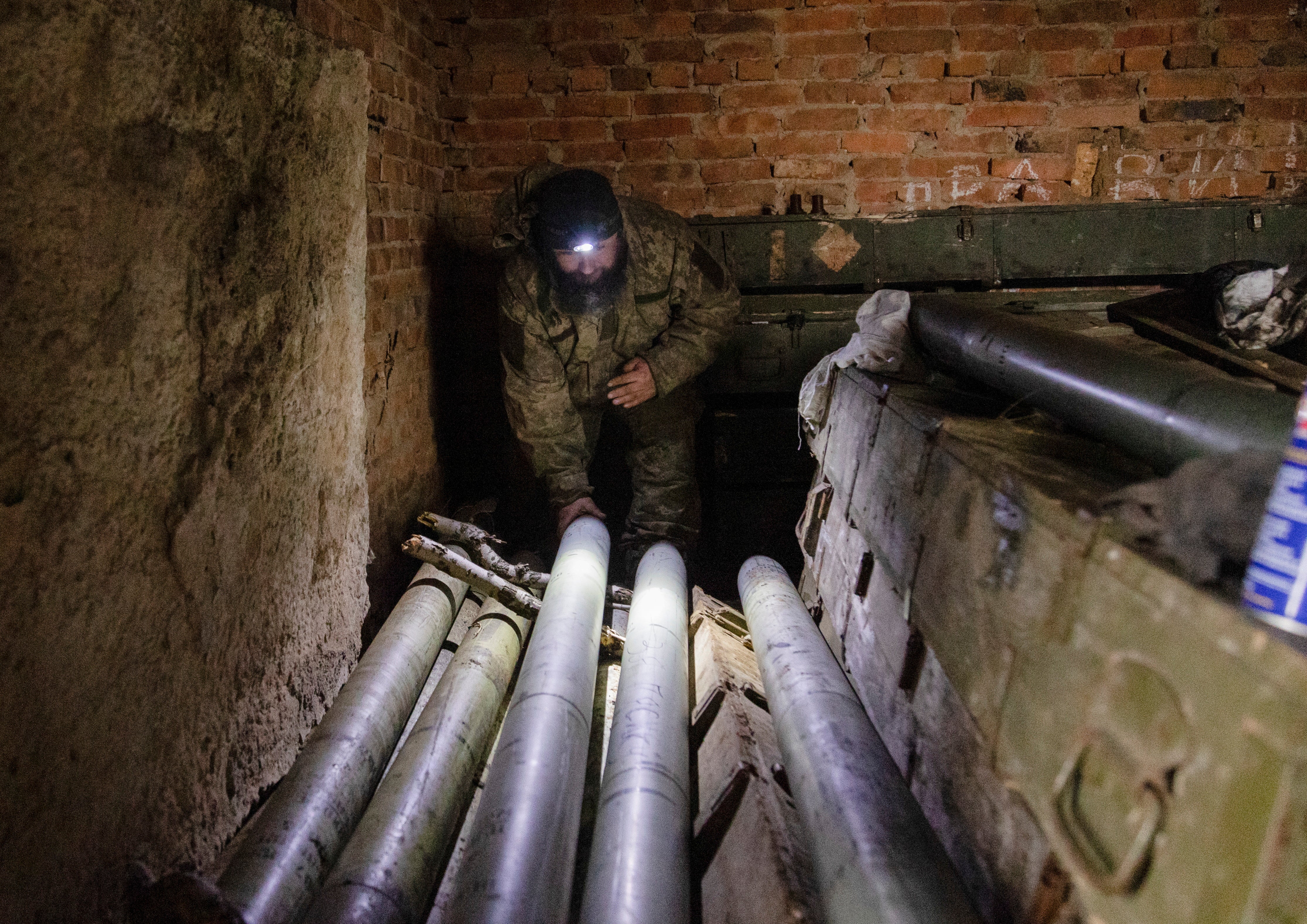 <p>Ukrainian servicemen prepare rockets to shoot from a self-made multiple rocket launcher on a frontline in Donetsk</p>