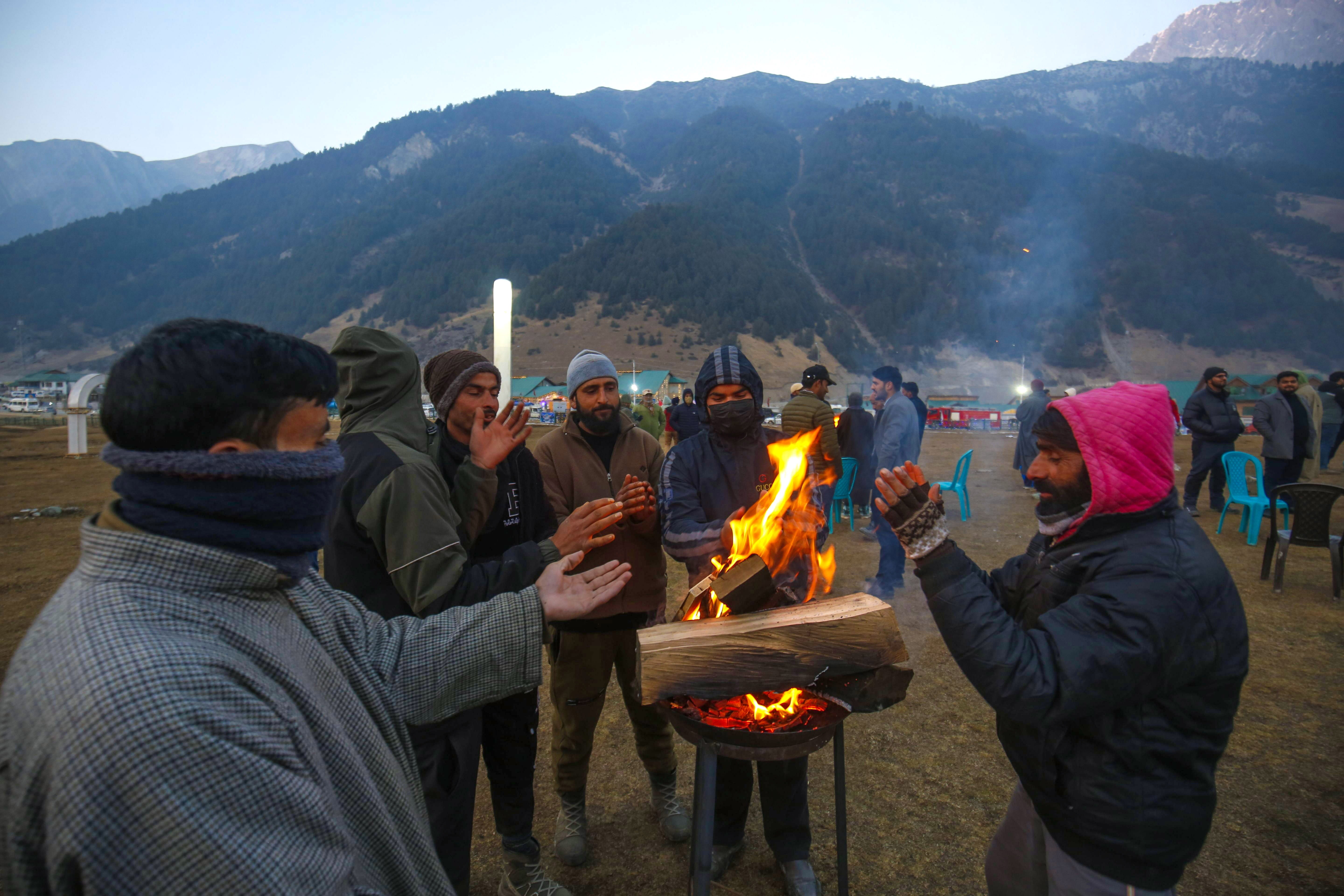 

<p>People warm themselves near a small fire as they attend the celebrations in Sonamarg, Indian Kashmir </p>
<p>” height=”3840″ width=”5760″ layout=”responsive” i-amphtml-layout=”responsive”><i-amphtml-sizer slot=