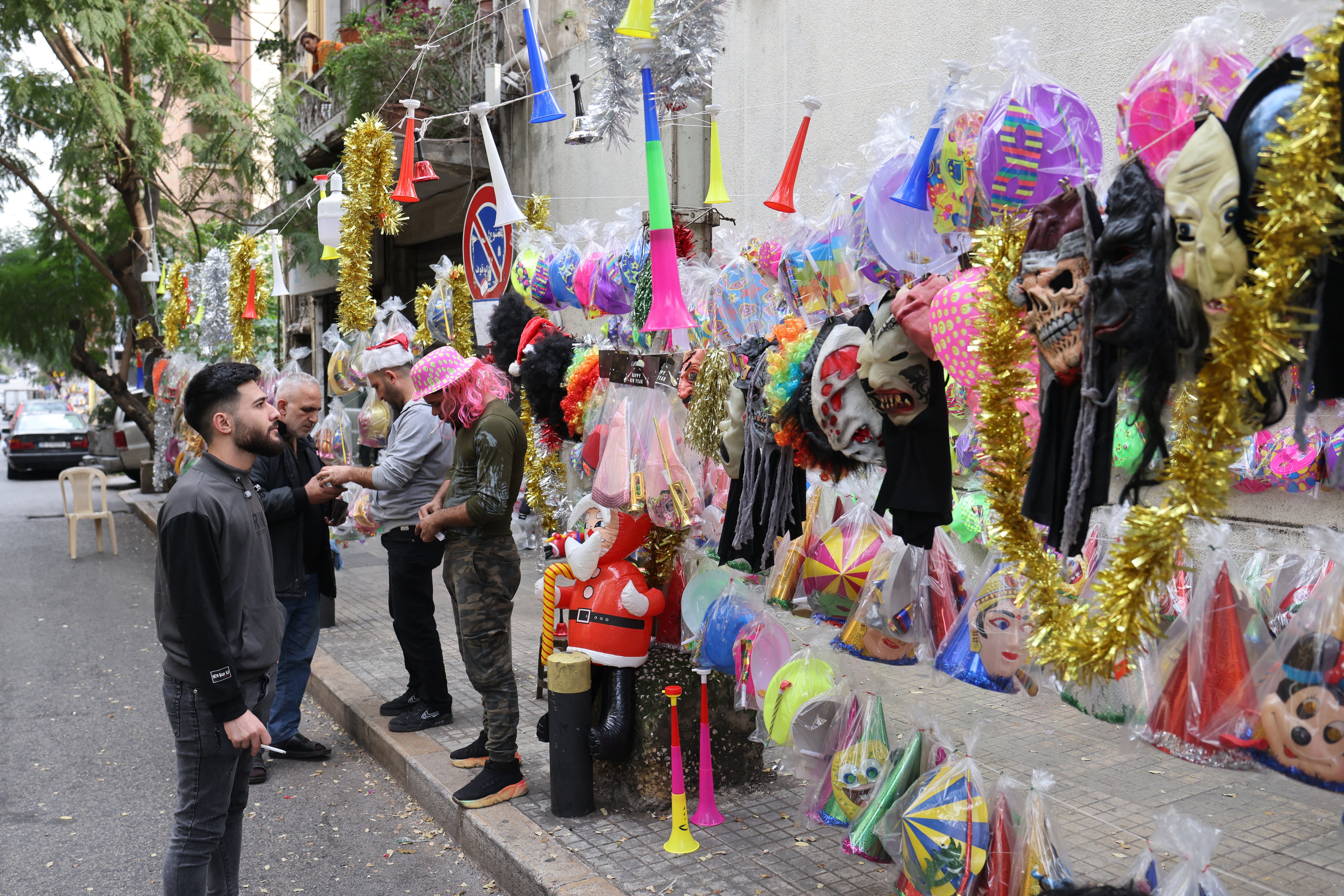 

<p>A street vendor sells festive party novelties for New Year’s Eve in Beirut</p>
<p>” height=”4394″ width=”6591″ layout=”responsive” i-amphtml-layout=”responsive”><i-amphtml-sizer slot=