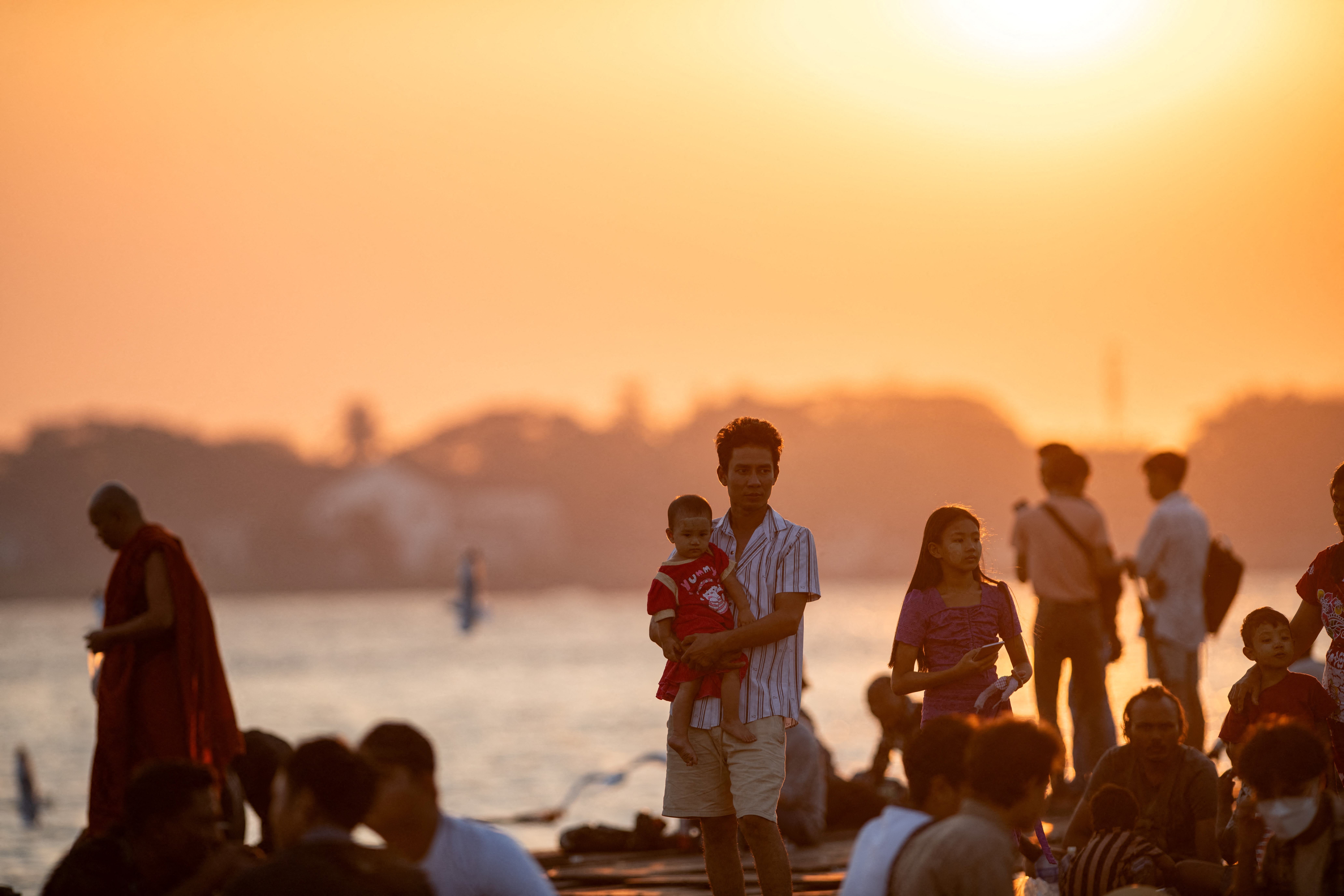

<p>People gather to observe the last sunset of the year at the Botahtaung jetty on Yangon River in Yangon</p>
<p>” height=”5504″ width=”8256″ layout=”responsive” i-amphtml-layout=”responsive”><i-amphtml-sizer slot=