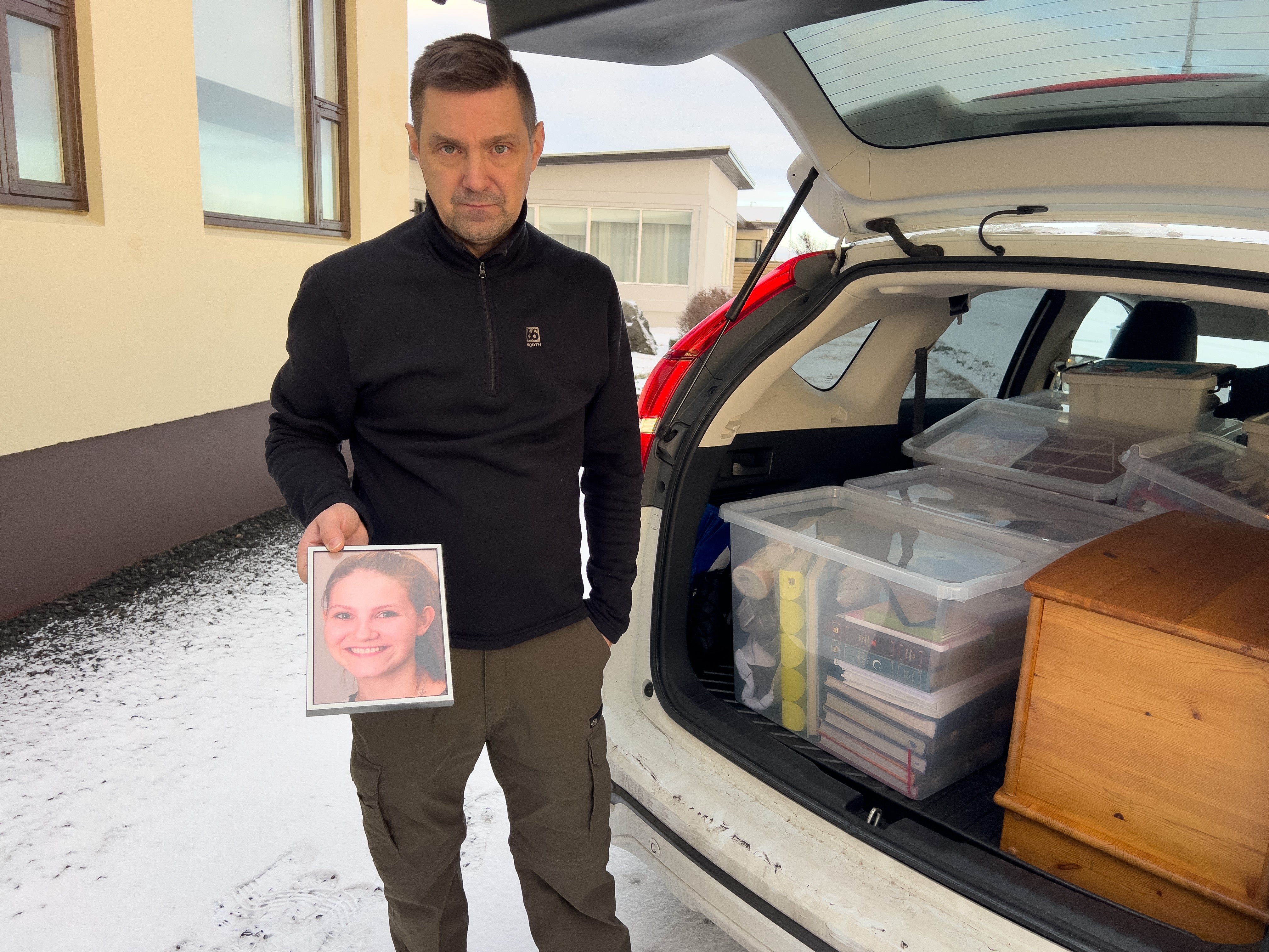 <p>A Grindavik resident packs up his belongings including a picture of his daughter Alma, who was killed in a car accident several years ago</p>