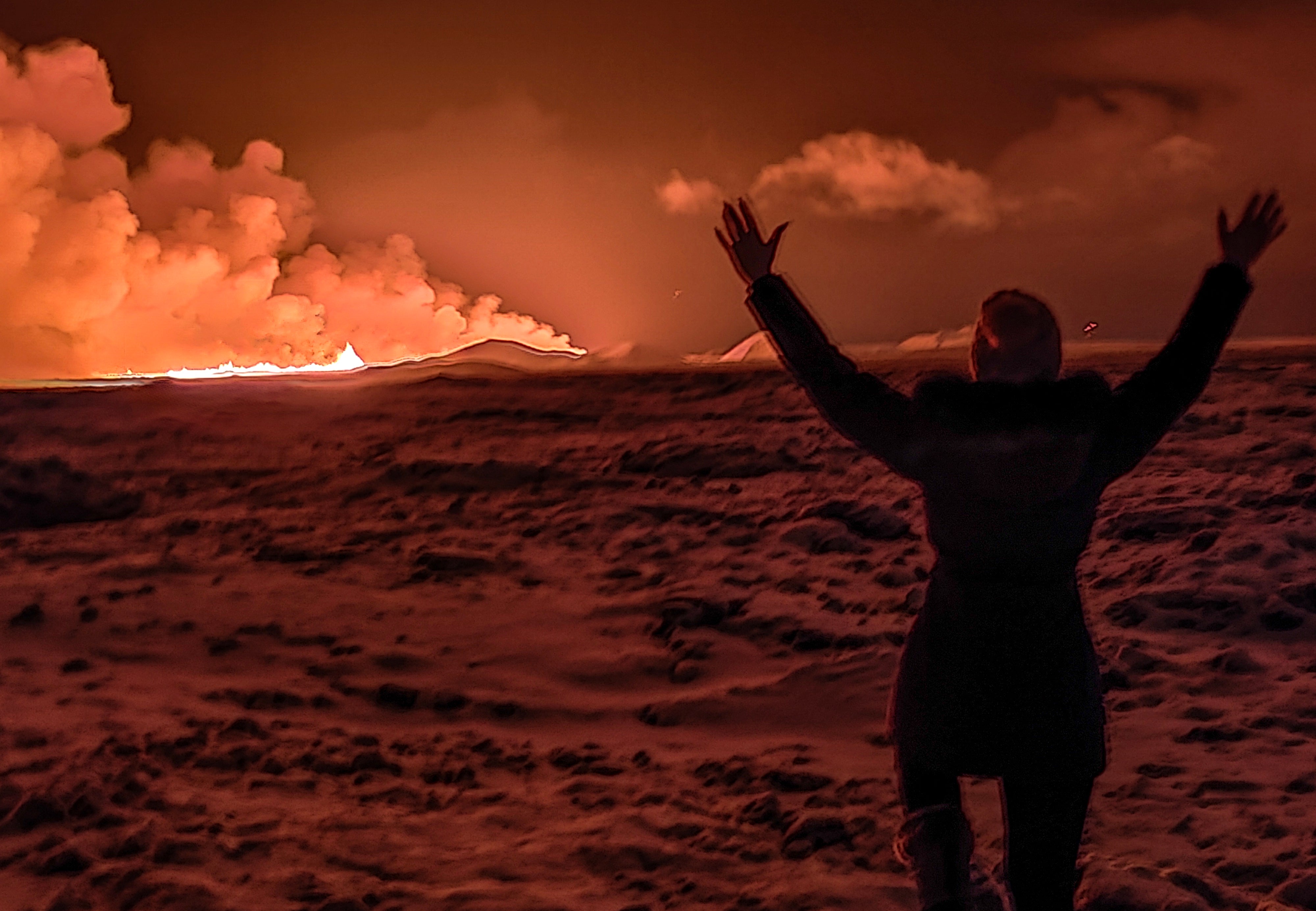 <p>A local resident watches the eruption </p>