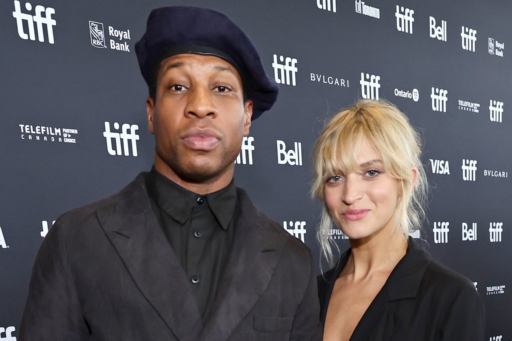 <p>TORONTO, ONTARIO - SEPTEMBER 12: (L-R) Jonathan Majors and guest Grace Jabbari attend the “Devotion” Premiere at Cinesphere on September 12, 2022 in Toronto, Ontario. (Photo by Matt Winkelmeyer/Getty Images)</p>