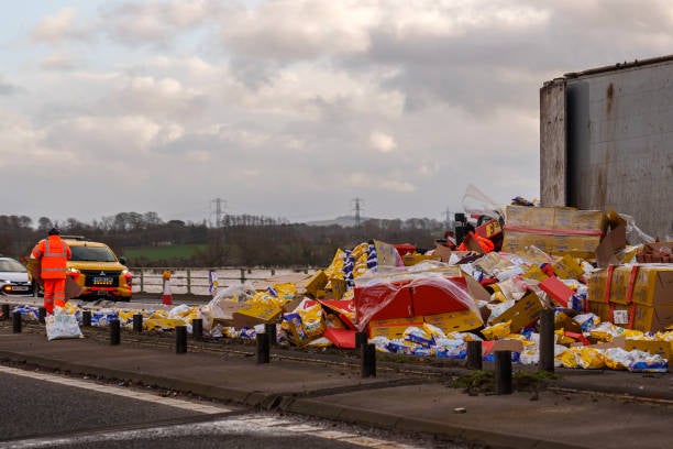 

<p>Workers clear up Wotsits and Quavers savoury snacks from the M6 motorway northbound after the wind overturned lorries on the carriageway on 22 January 2024 in Carlisle, United Kindom</p>
<p>” height=”408″ width=”612″ layout=”responsive” i-amphtml-layout=”responsive”><i-amphtml-sizer slot=