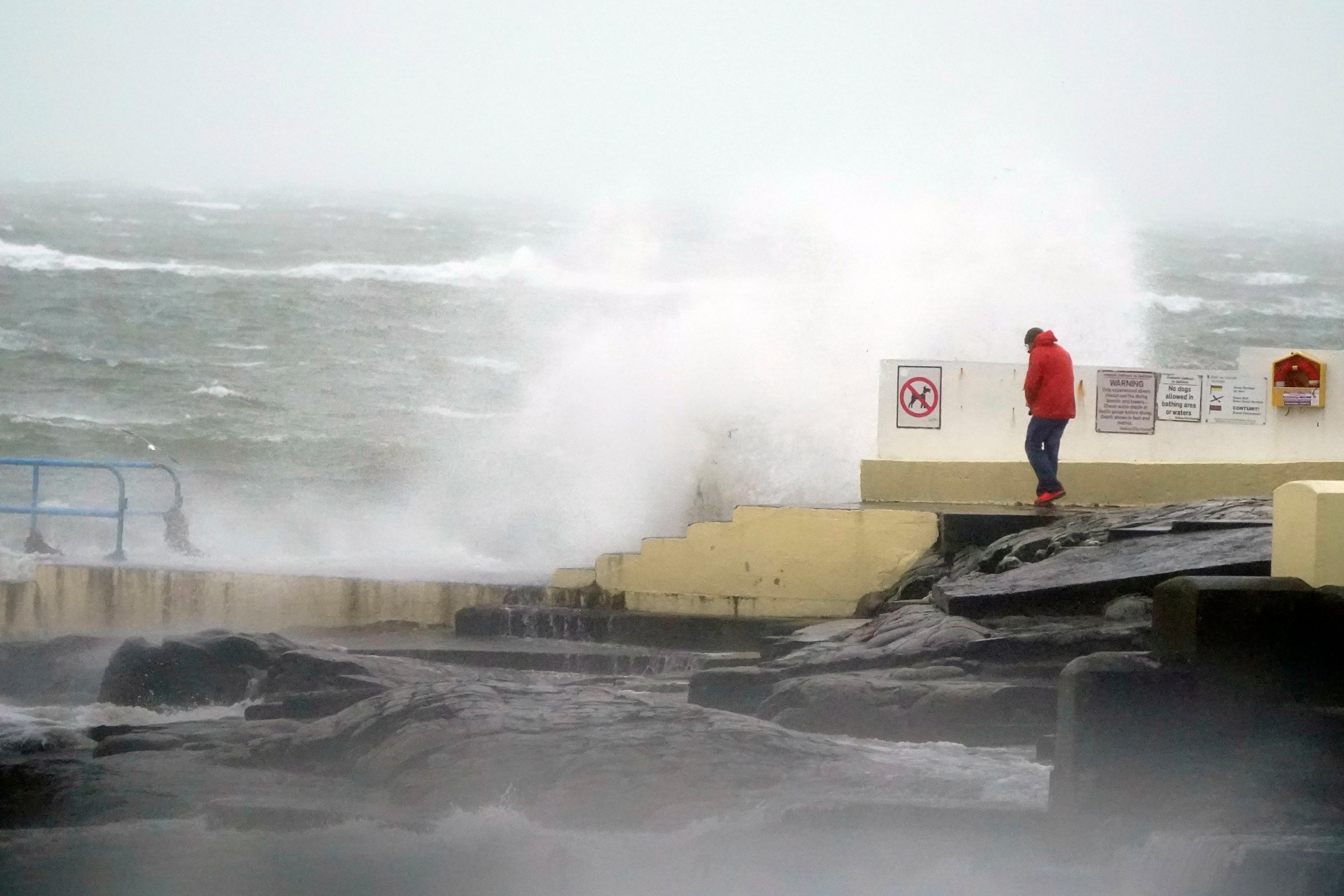

<p>A person looking at high waves in Salthill, Galway, during Storm Isha</p>
<p>” height=”2624″ width=”3936″ layout=”responsive” i-amphtml-layout=”responsive”><i-amphtml-sizer slot=