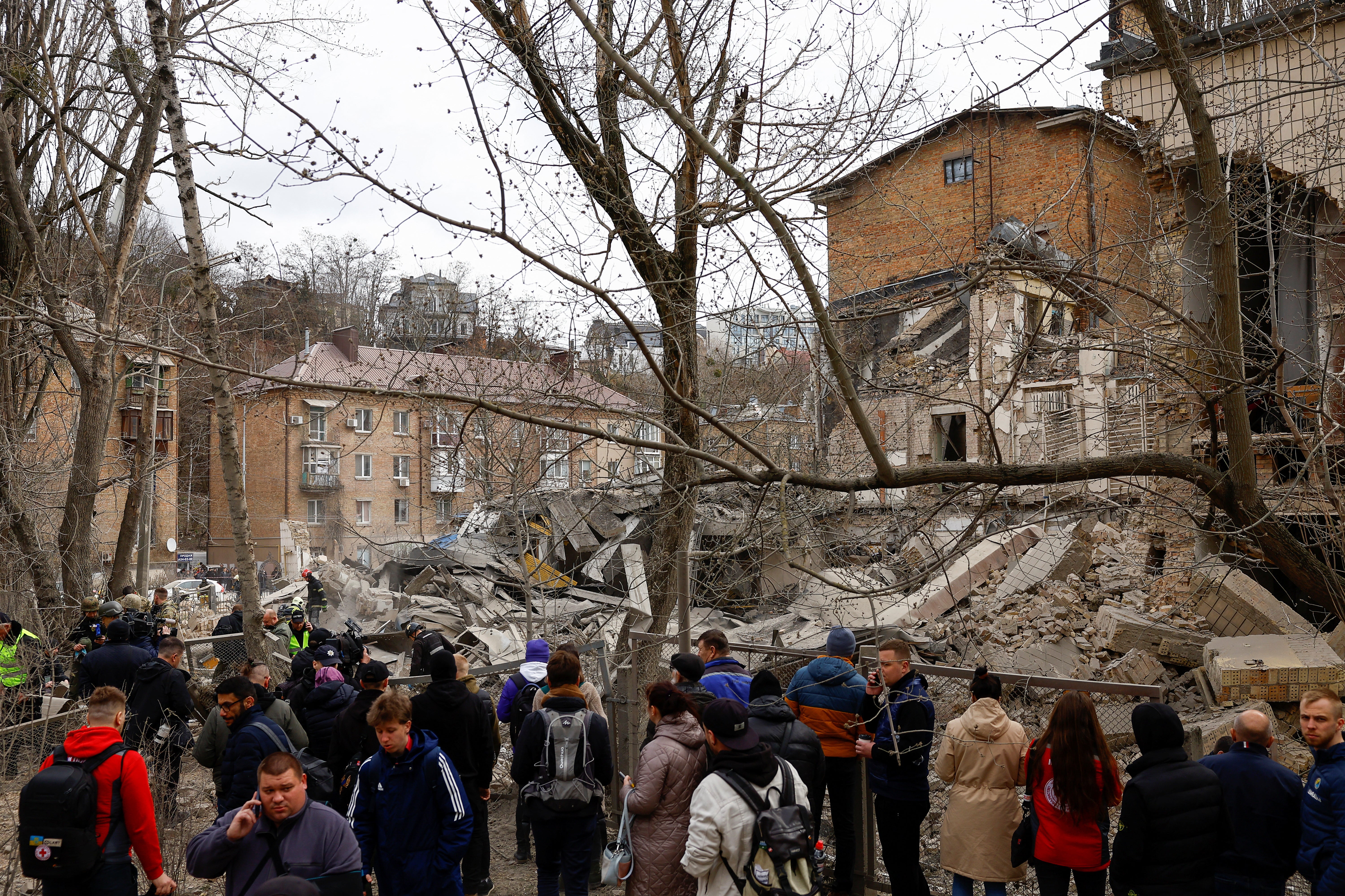 

<p>People watch as rescuers work at the site of a building damaged by a Russian missile strike in Kyiv on Monday </p>
<p>” height=”4000″ width=”6000″ layout=”responsive” i-amphtml-layout=”responsive”><i-amphtml-sizer slot=