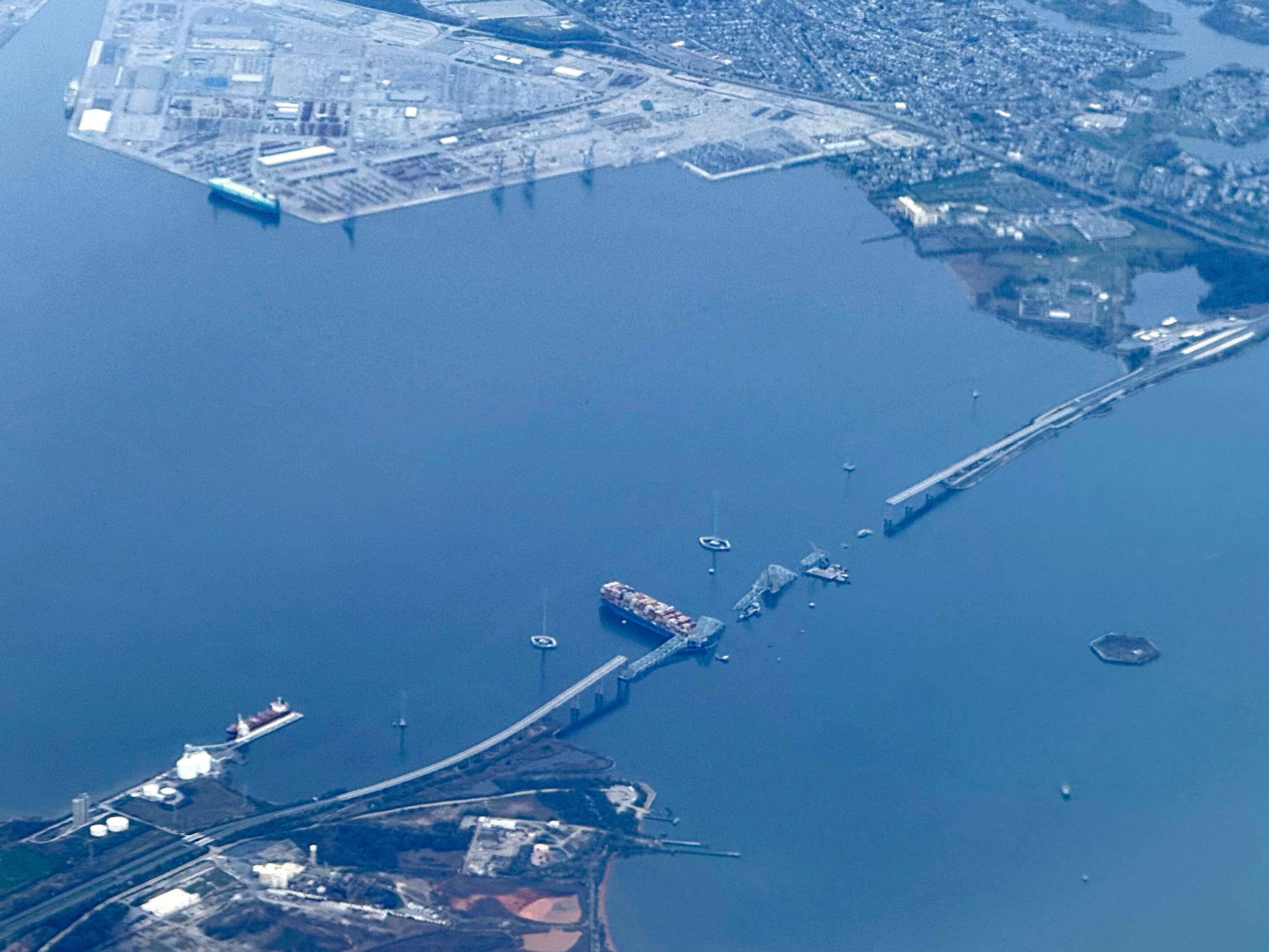 

<p>This aerial view shows the collapsed Francis Scott Key Bridge lying on top of the container ship Dali in Baltimore</p>
<p>” height=”2149″ width=”2865″ layout=”responsive” i-amphtml-layout=”responsive”><i-amphtml-sizer slot=