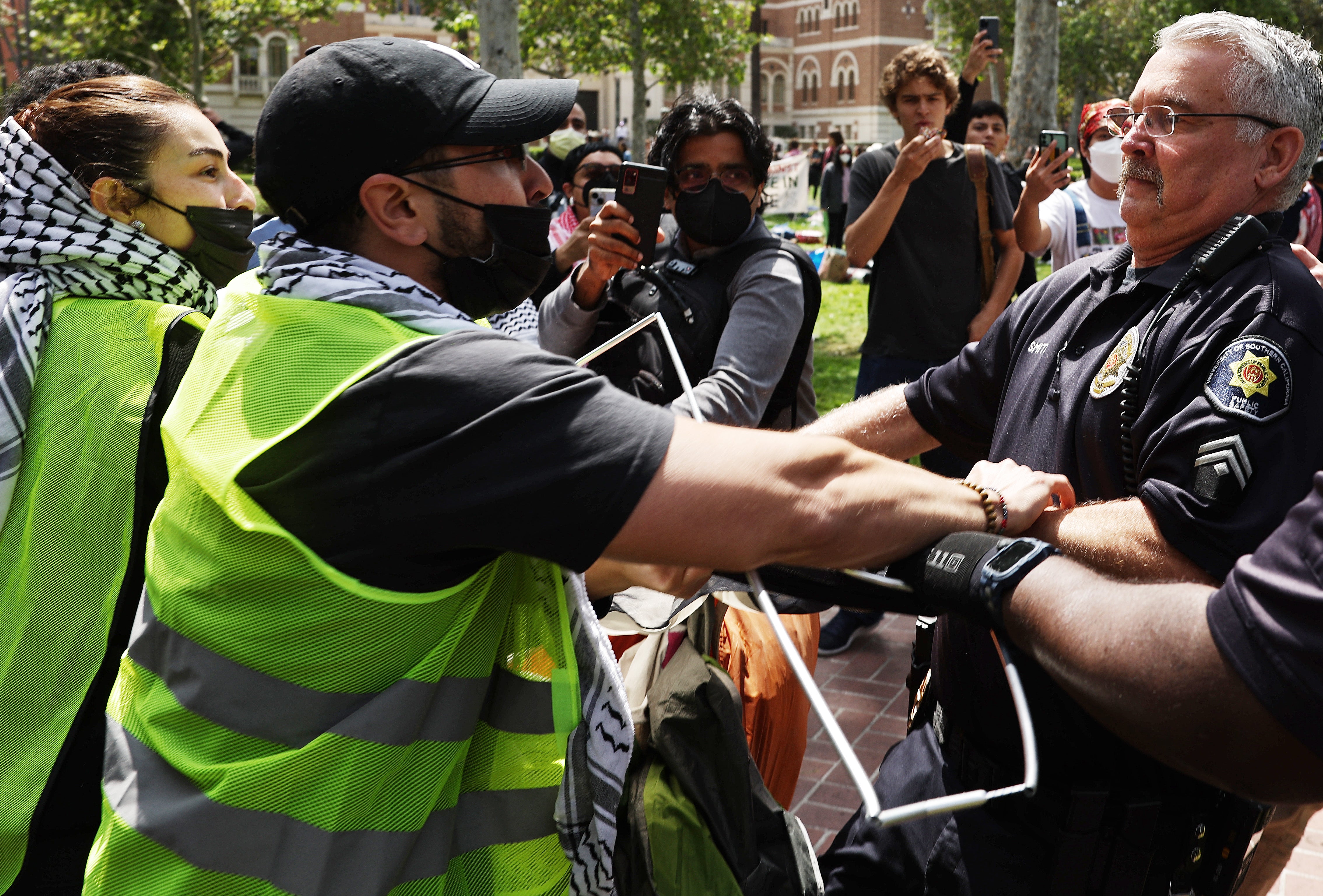 A USC public safety officer scuffles with pro-Palestine supporters as officers attempt to take down an encampment in support of Gaza at the University of Southern California on April 24, 2024 in Los Angeles, California