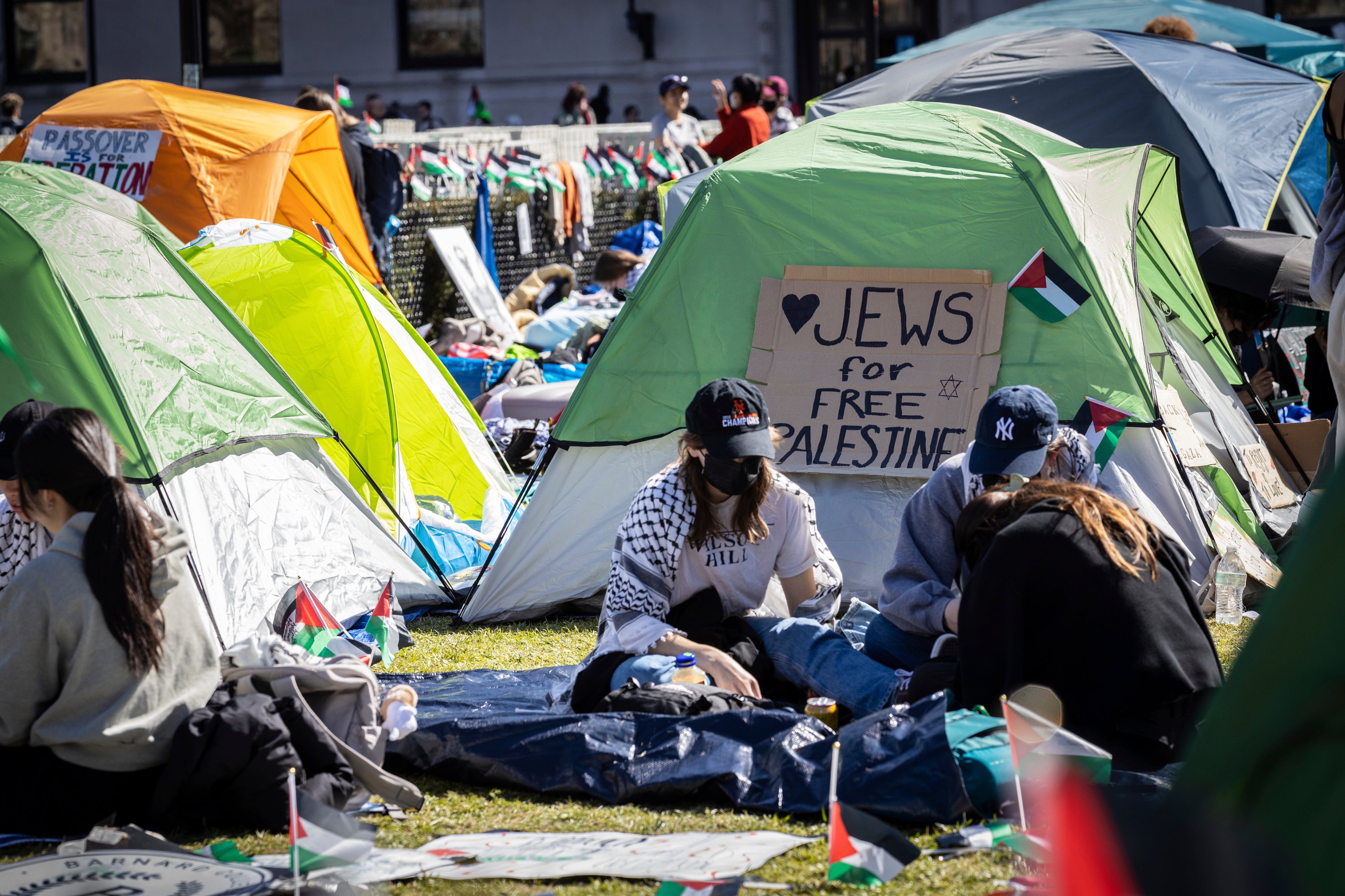 Student protesters sit in front of a tent during the Pro-Palestinian protest at the Columbia University campus in New York, Monday April 22, 2024