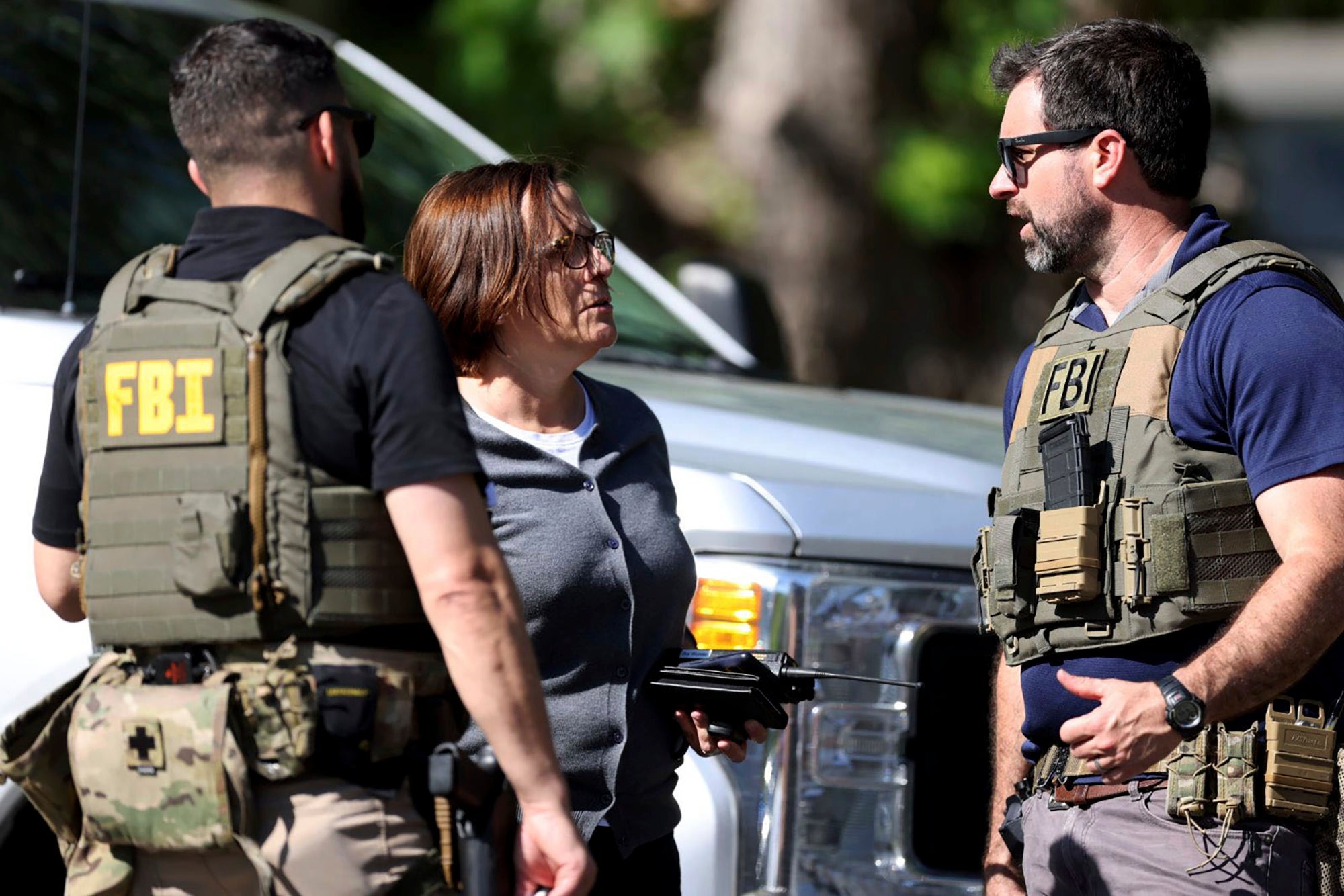 Members of FBI talk with each other at the scene of a shooting on Galway Drive in Charlotte