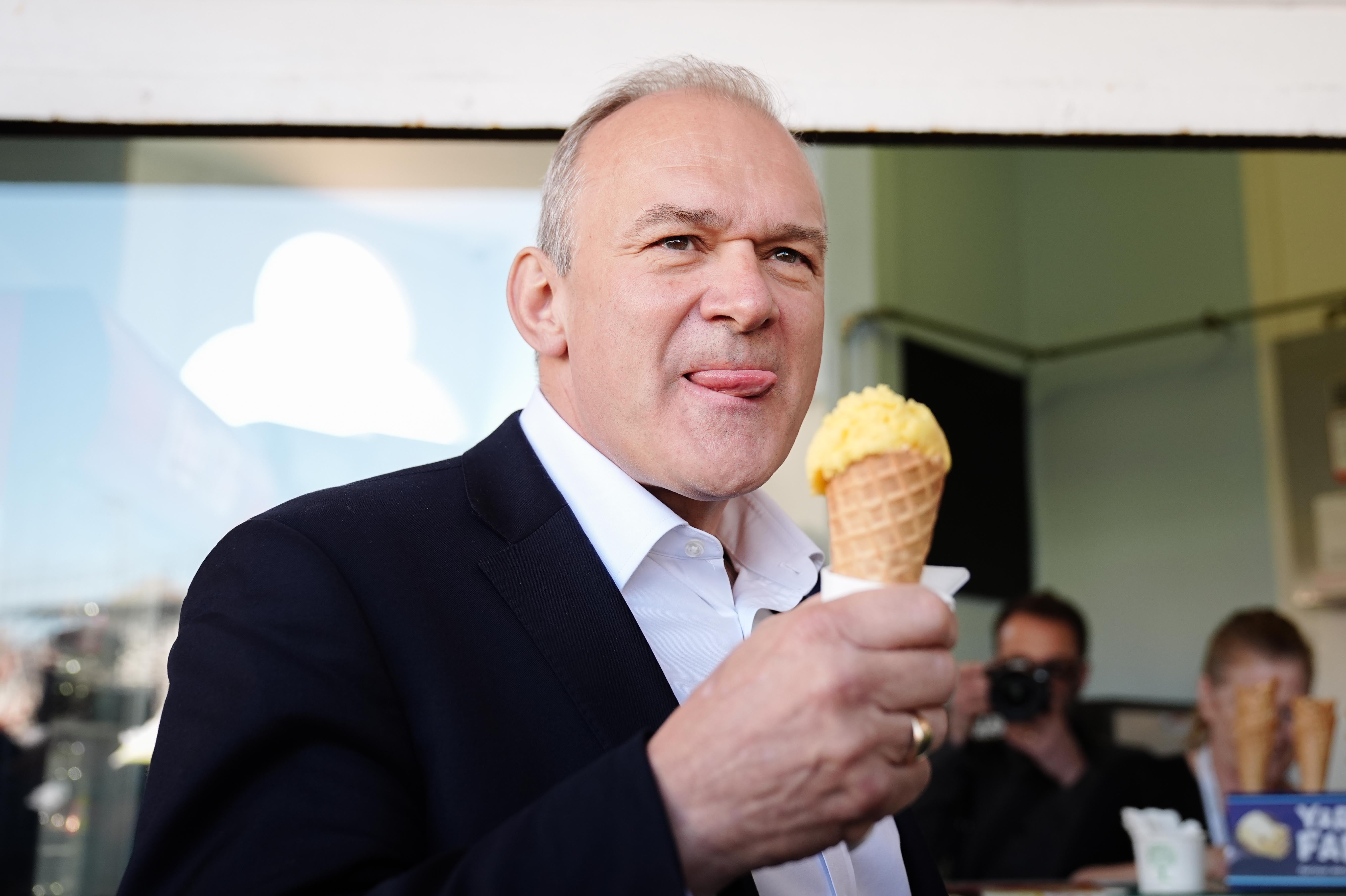 Liberal Democrat leader Sir Ed Davey eats ice cream on the promenade in Eastbourne, East Sussex, while on the General Election campaign trail