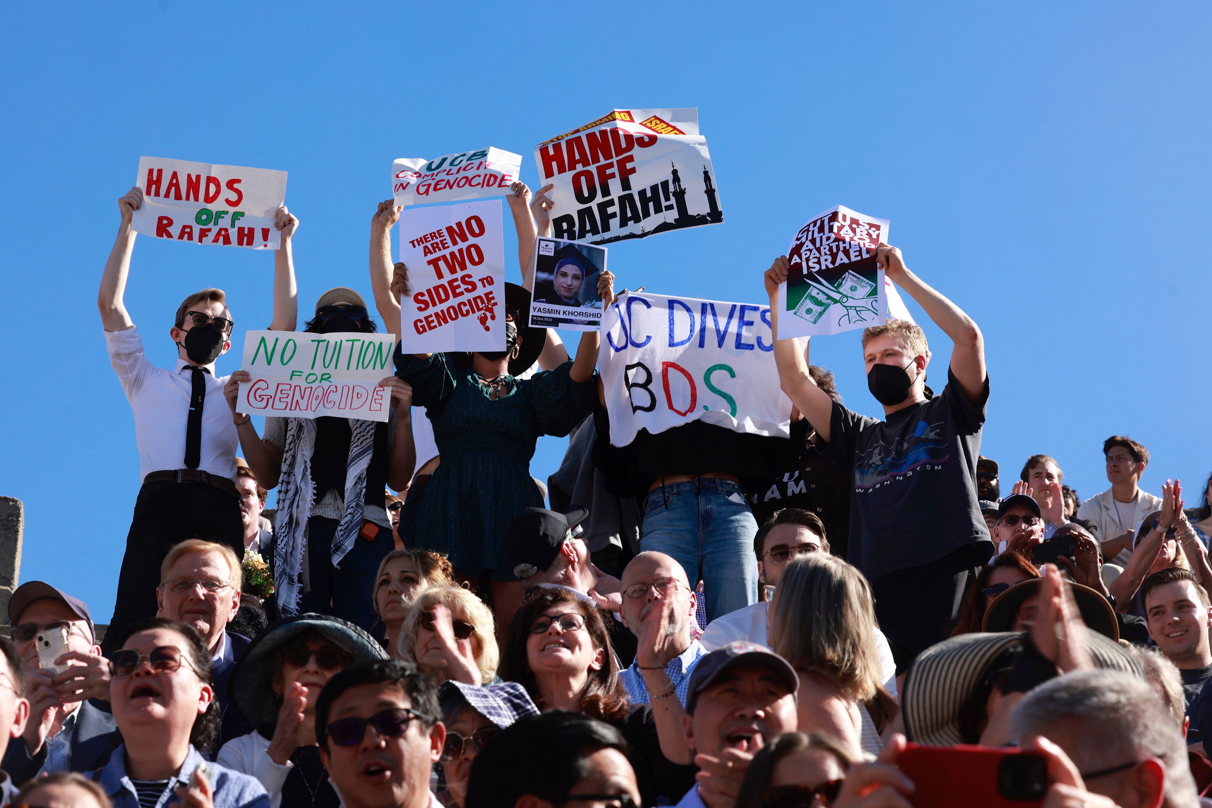 Demonstrators hold up signs as a second pro-Palestine protest interrupts the UC Berkeley Law School