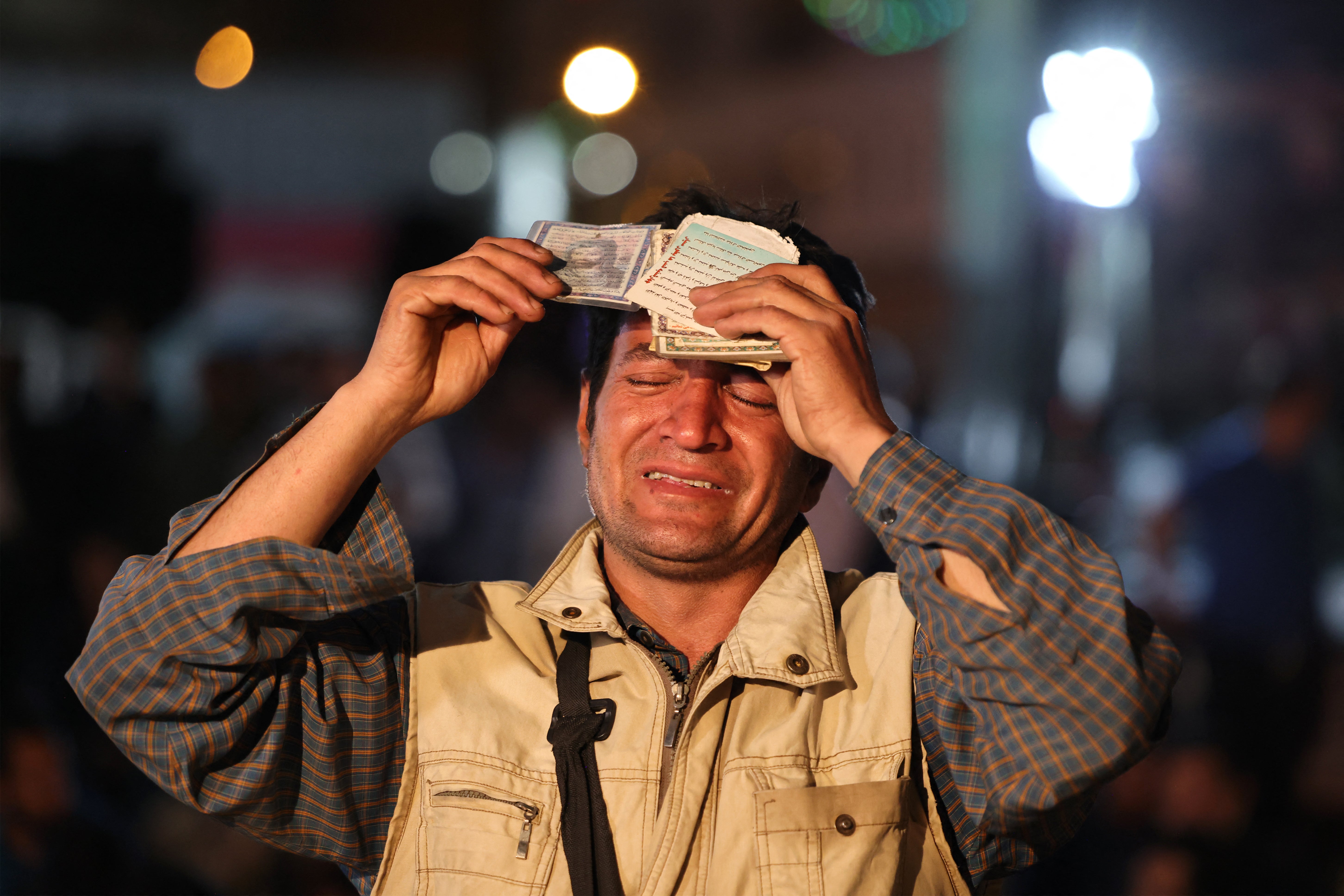 An Iranian man prays for president Ebrahim Raisi in central Tehran