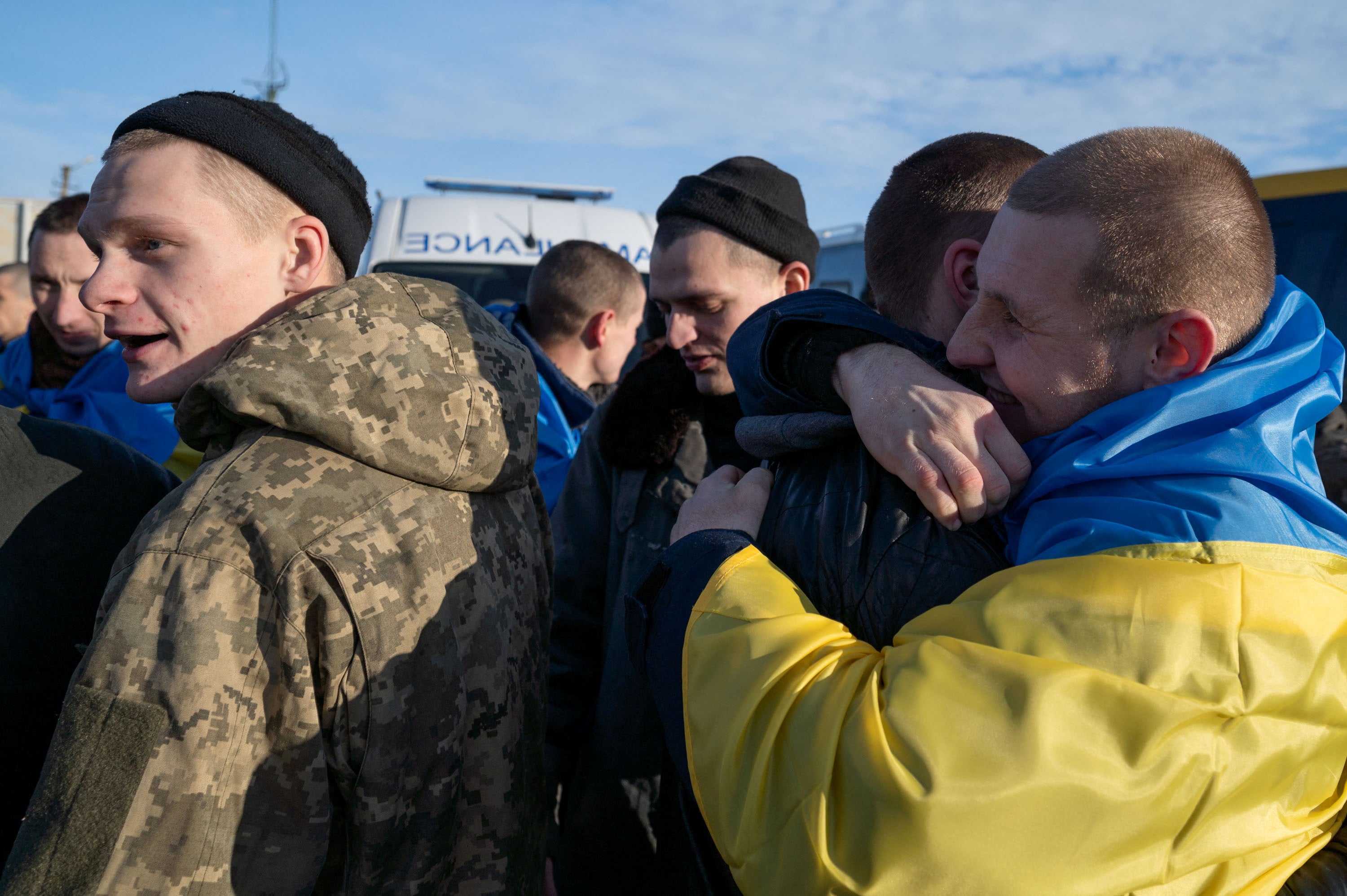 Ukrainian prisoners of war (POWs) react after a swap at an unknown location in Ukraine in January