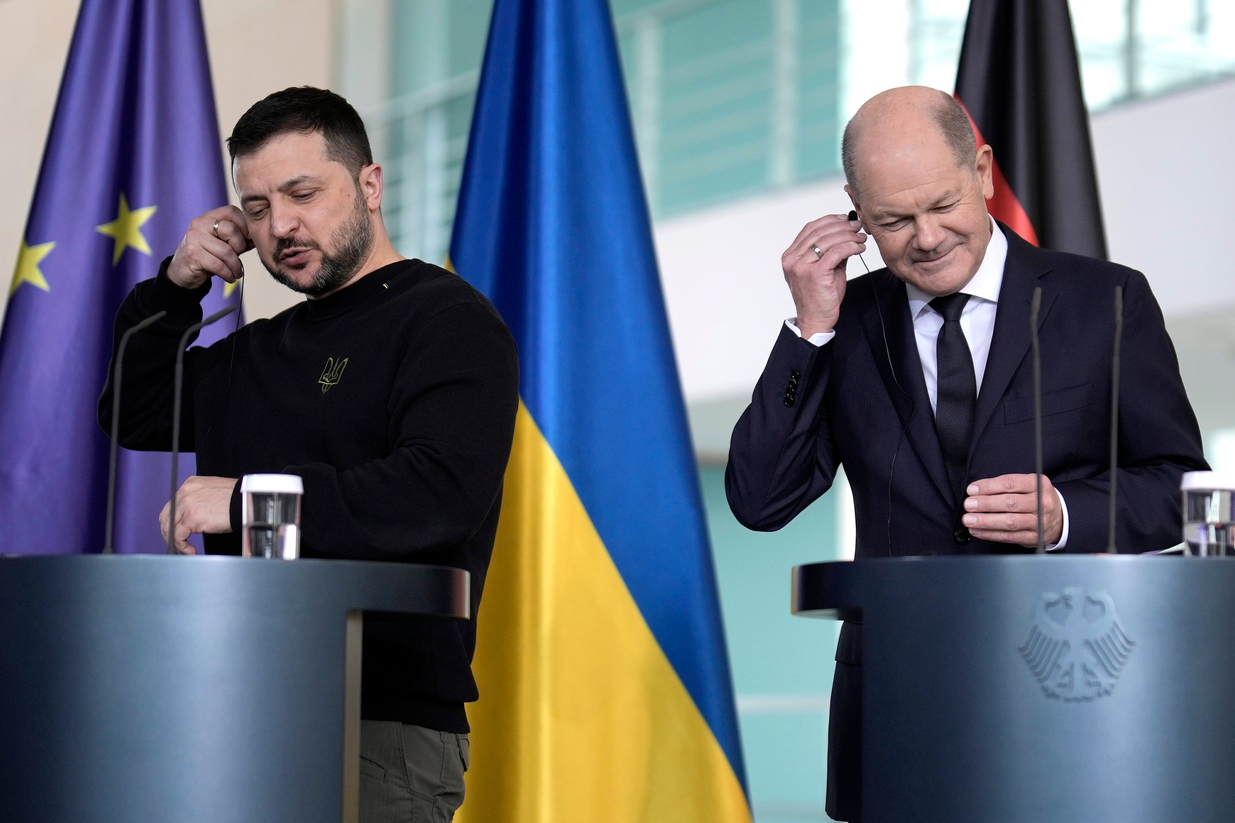 German Chancellor Olaf Scholz, right, and Ukrainian President Volodymyr Zelenskyy speak ahead of the Germany Ukraine Recovery Conference