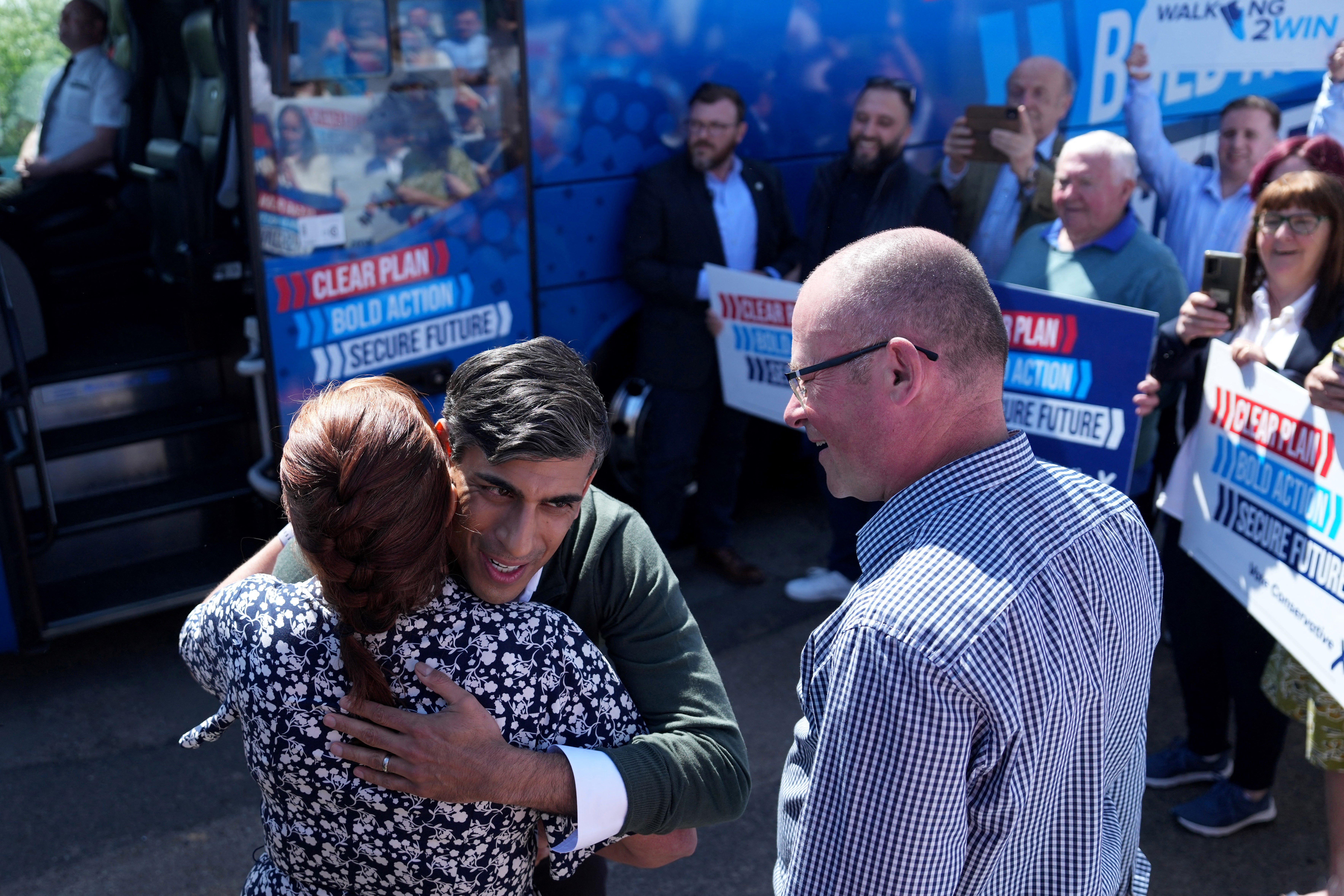 Britain's Prime Minister and Conservative Party leader Rishi Sunak (C) greets the party's Cramlington and Killingworth candidate Ian Levy and Blyth and Ashington candidate Maureen Levy during a campaign visit to Blyth