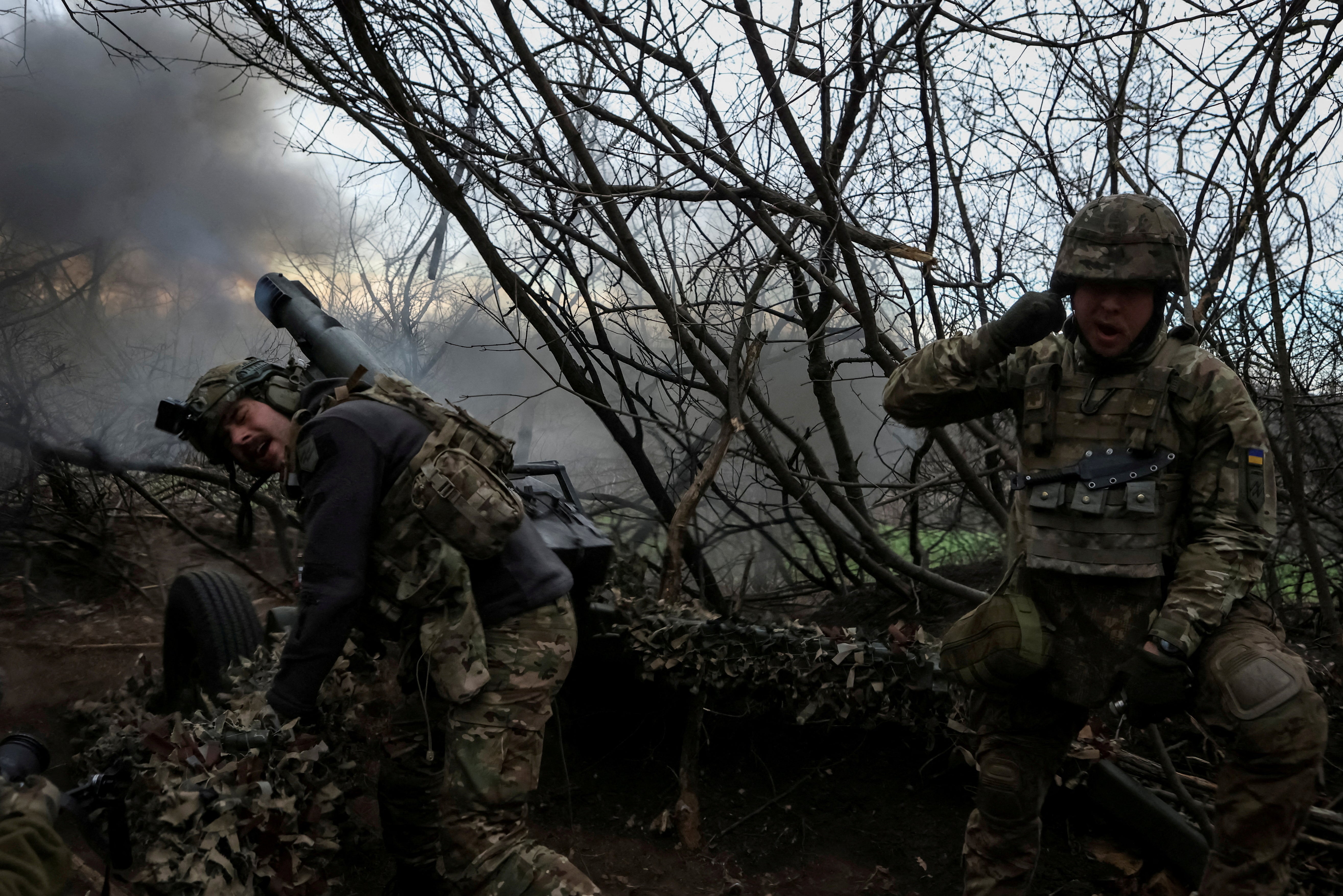 Servicemen of the 12th Special Forces Brigade Azov of the National Guard of Ukraine fire a howitzer towards Russian troops, amid Russia’s attack on Ukraine, in Donetsk region