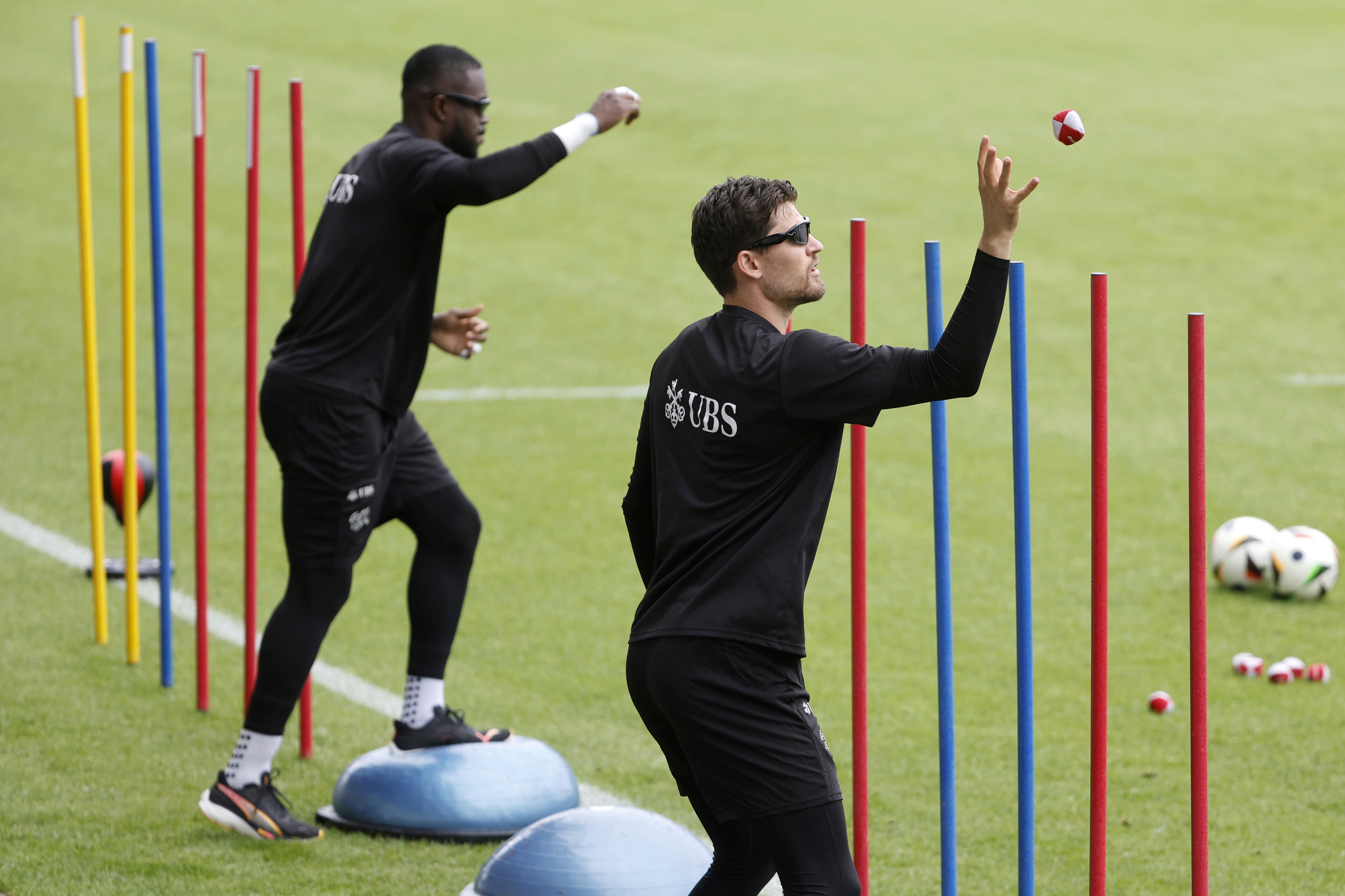 Switzerland's goalkeepers Gregor Kobel, right, and Yvon Mvogo attend a training session