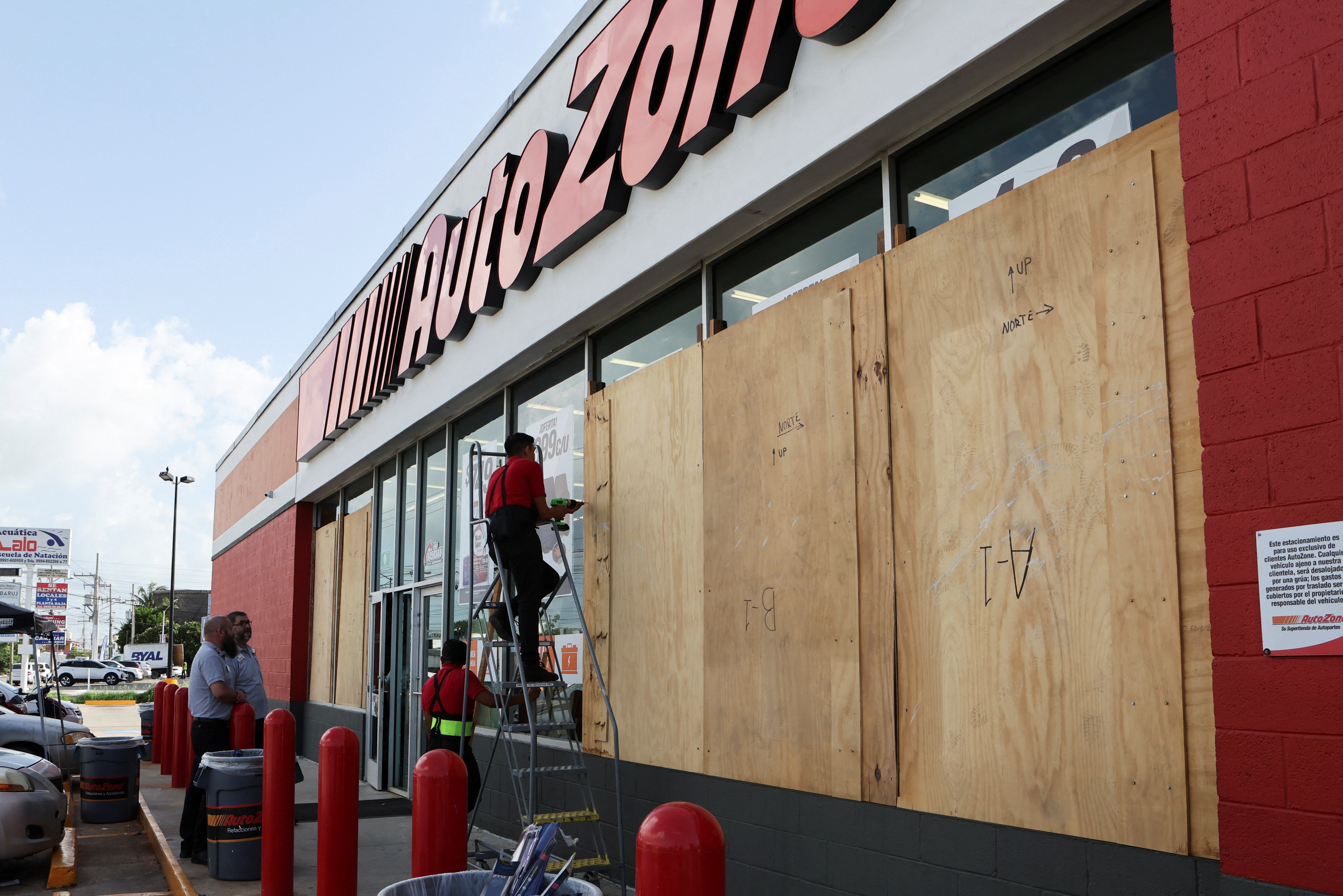 Workers board up a business to avoid damage ahead of Hurricane Beryl, in Merida, Mexico on July 3