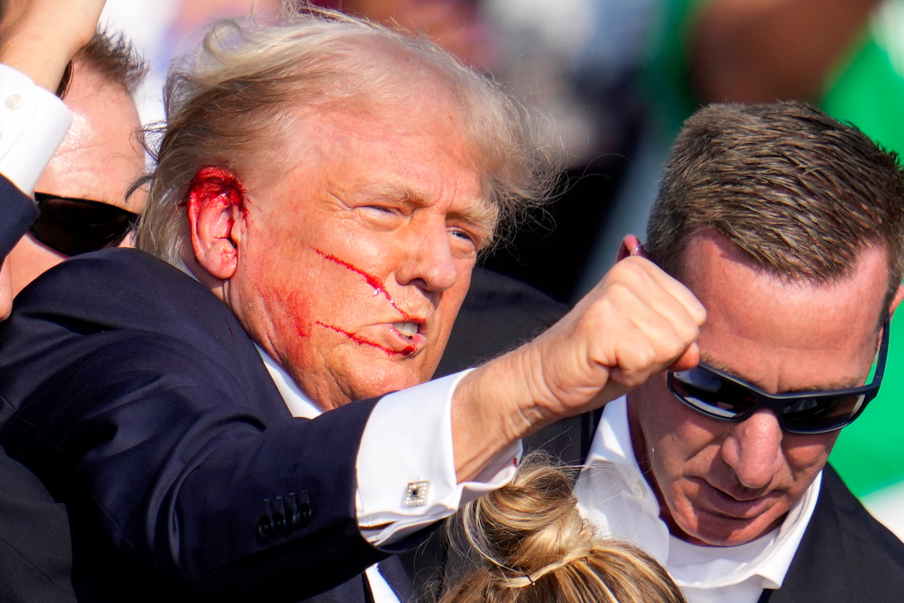 Republican presidential candidate and former president Donald Trump reacts following an assassination attempt at a campaign event in Butler, Pennsylvania, on Saturday night