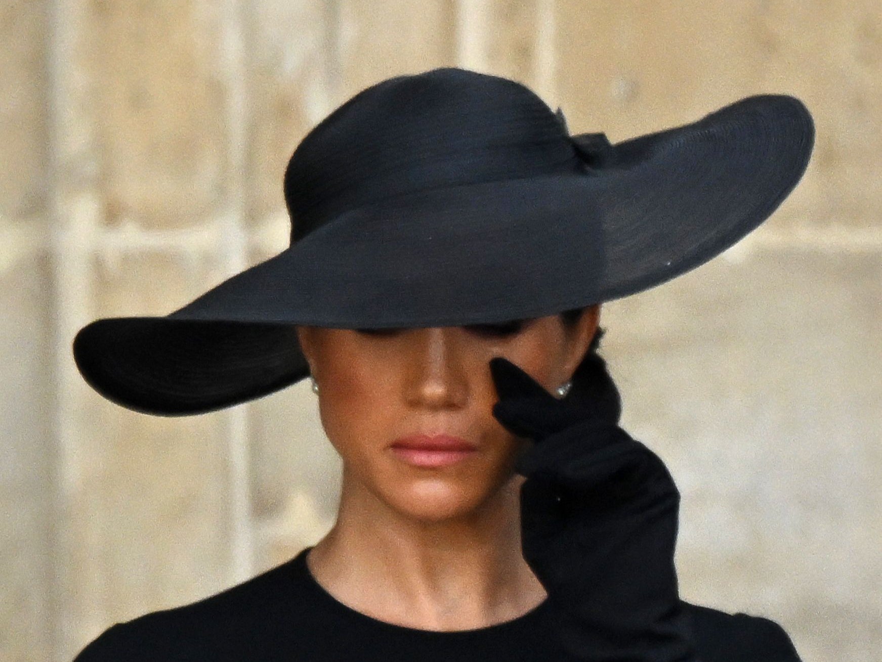 Meghan Markle appears to wipe away tears during Queen’s funeral. She has not visited the UK since it took place in September 2022.