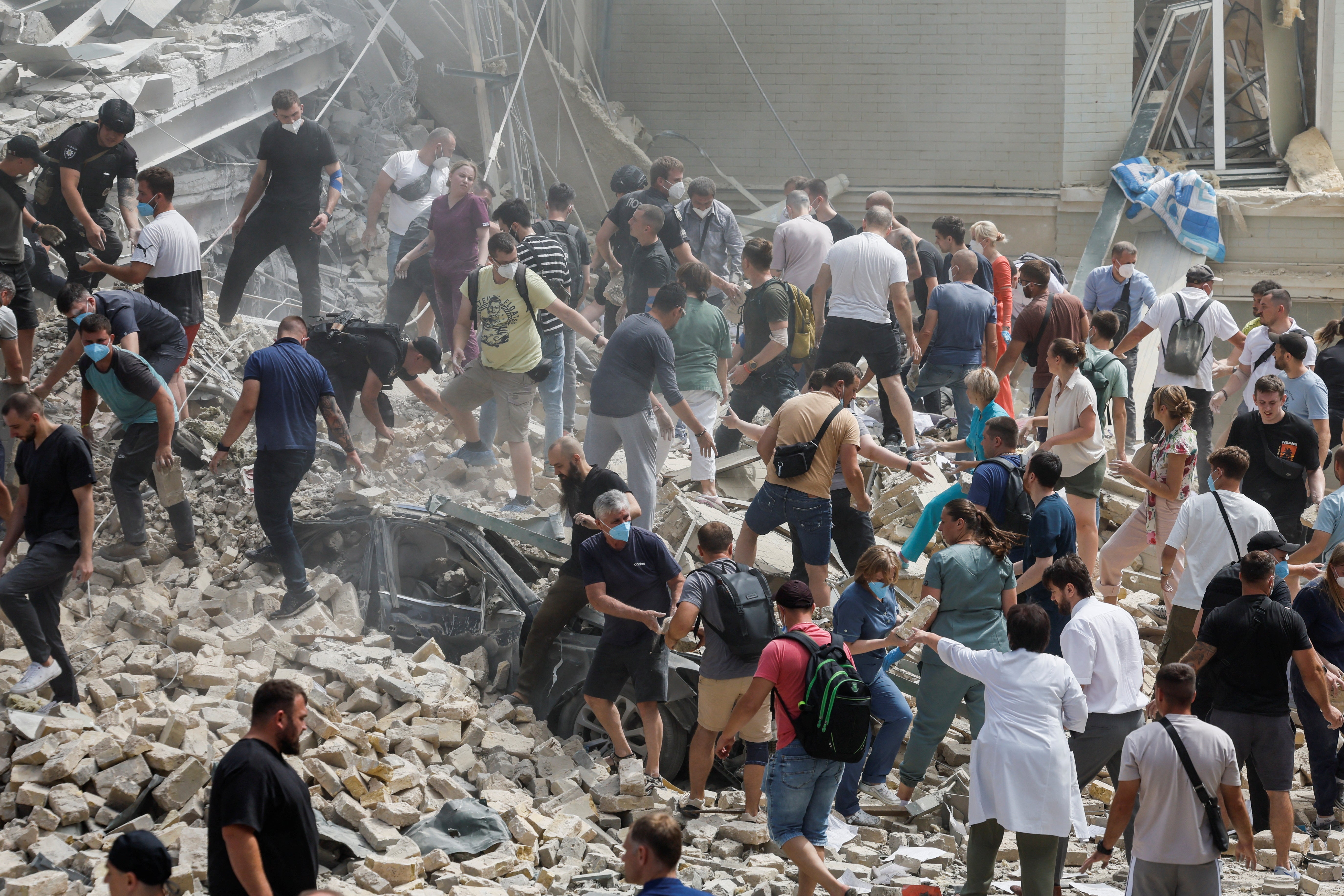 Ukrainians search through rubble after a children’s hospital was hit in a Russian attack on Kyiv