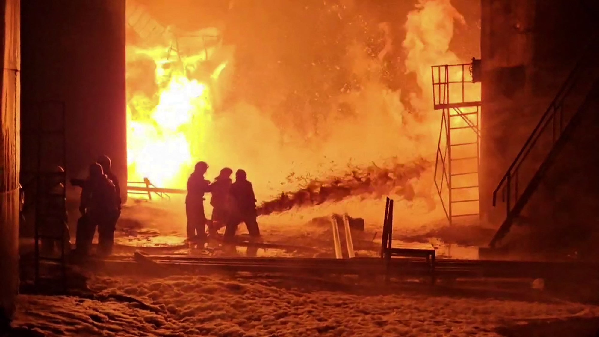 This grab from a handout footage published on the official Telegram account of the governor of the Kursk region Roman Starovoit on February 15, 2024, shows firefighters working to extinguish a fire at an oil depot in the Kursk region