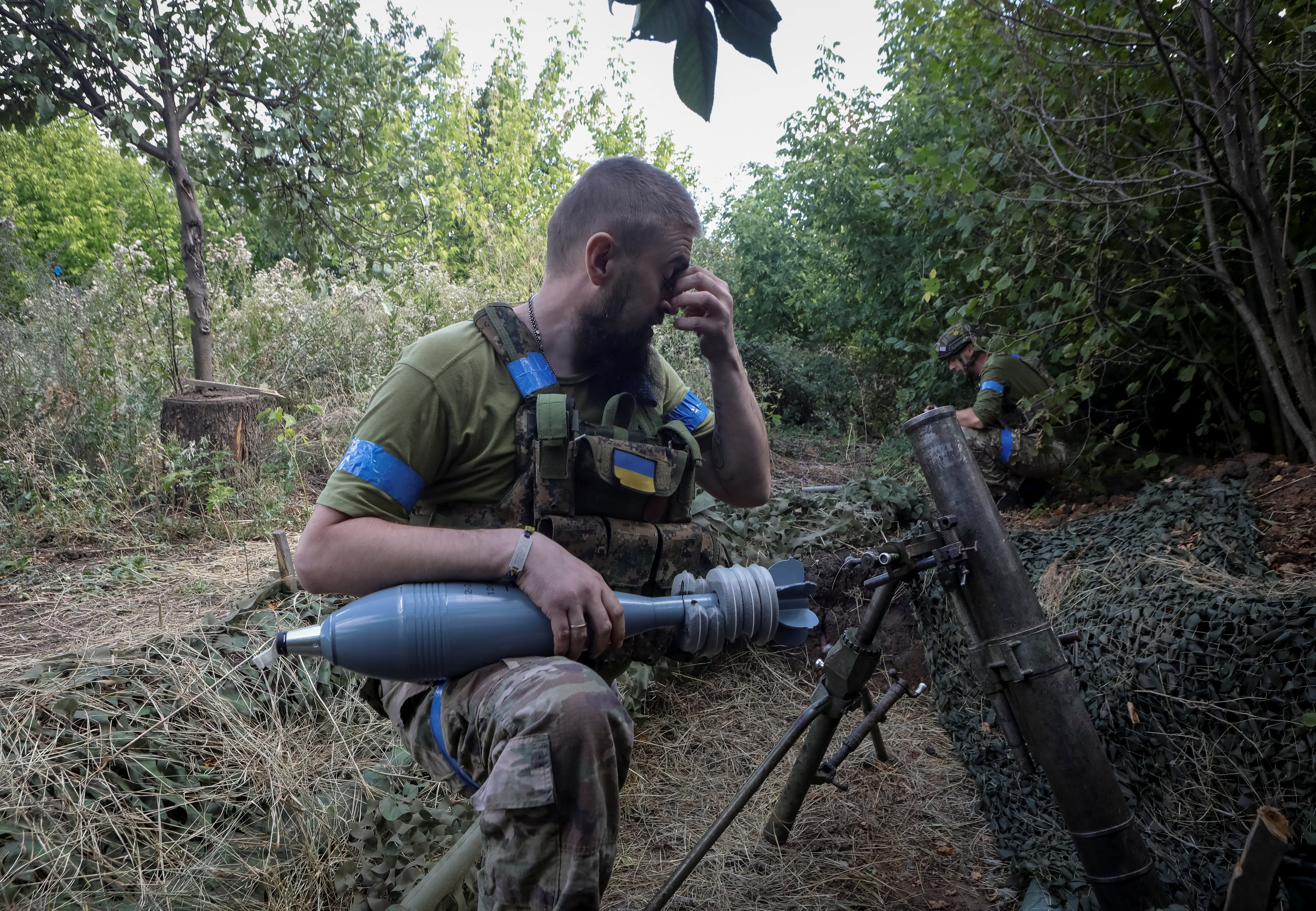 A Ukrainian soldier prepares to fire a 120-mm mortar towards Russian troops in Donetsk