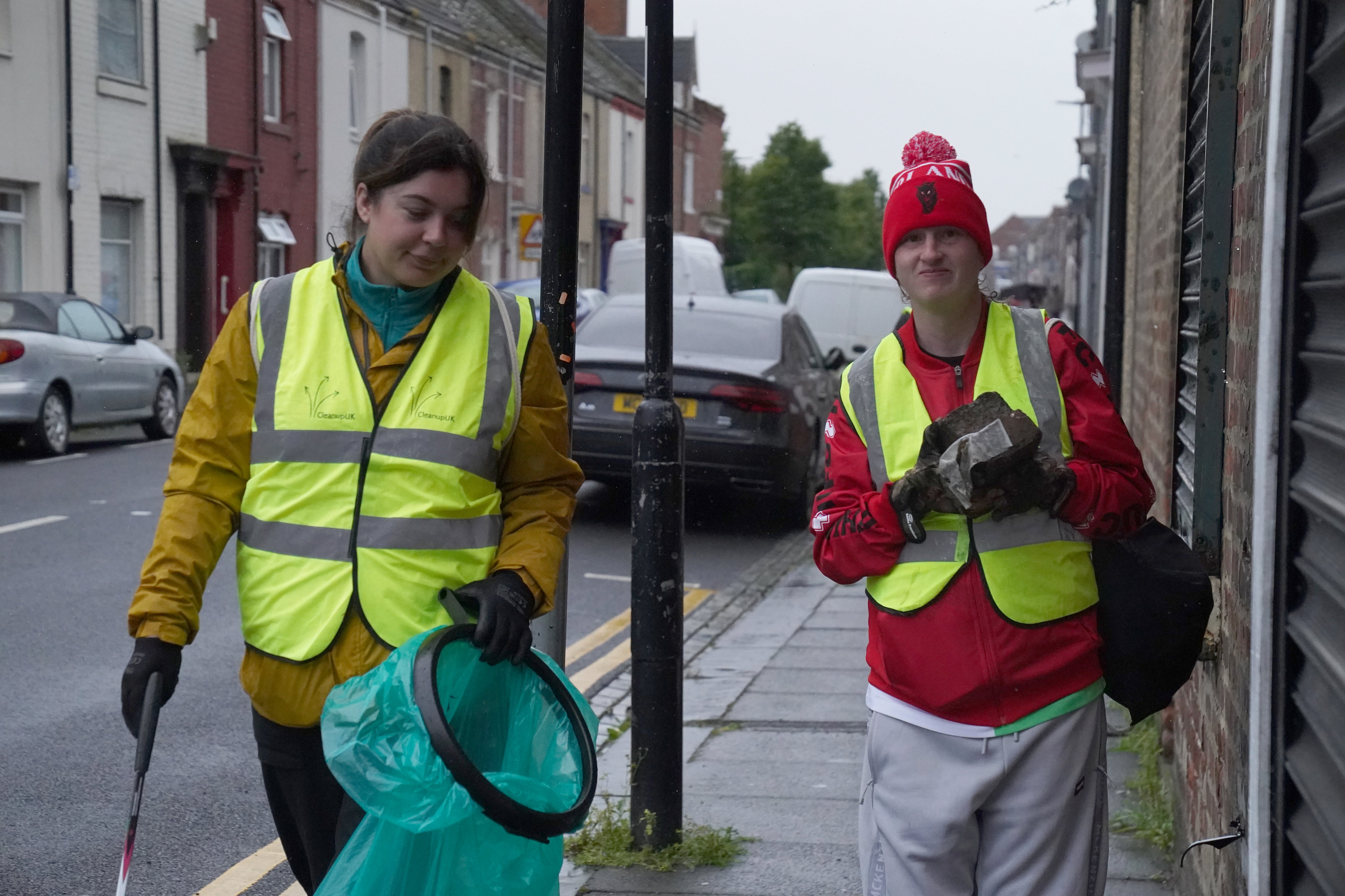 Volunteers clear debris on Murray Street in Hartlepool following a violent protest on Wednesday evening