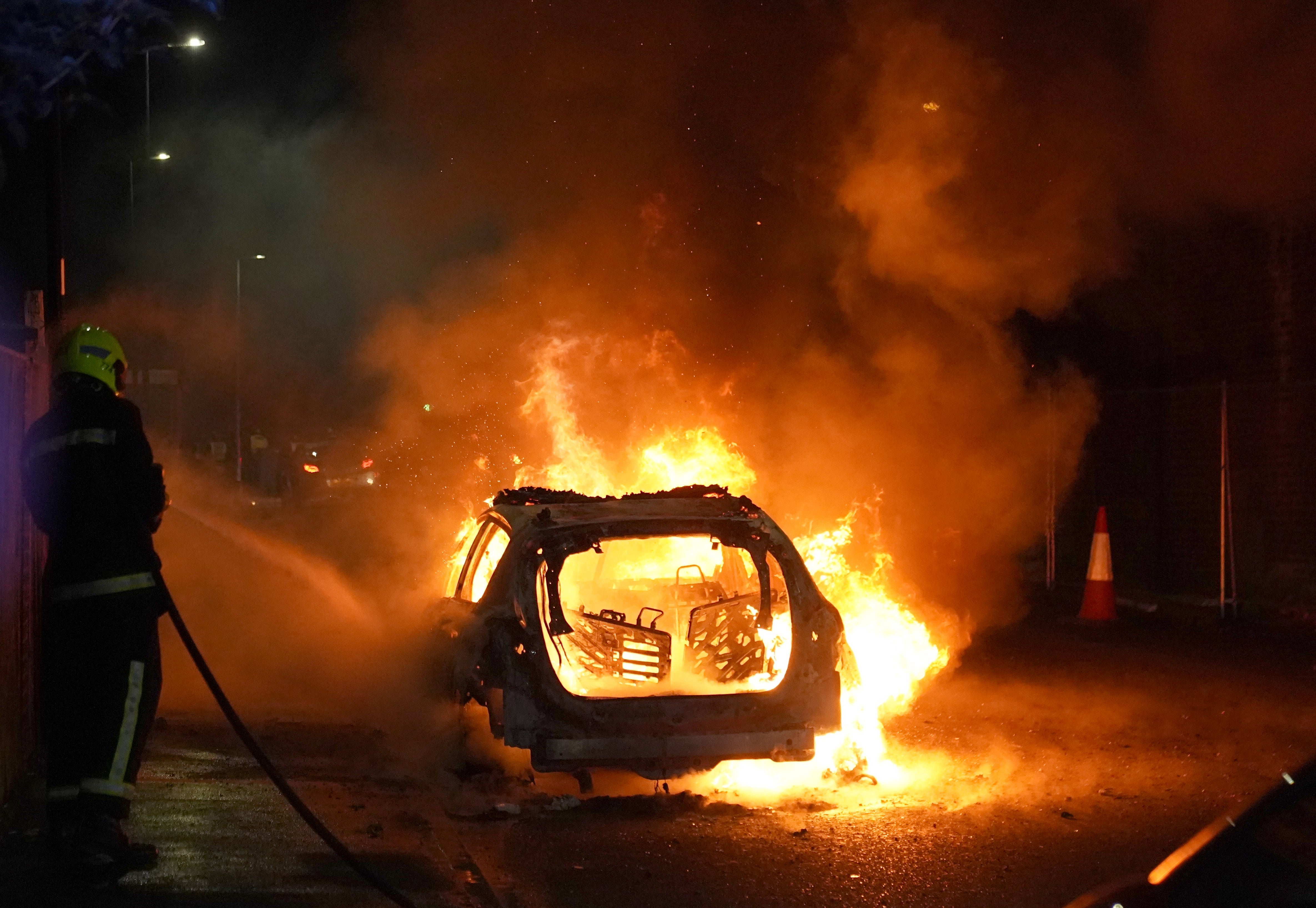 Demonstrators in Hartlepool set fire to a police car during clashes with police officers