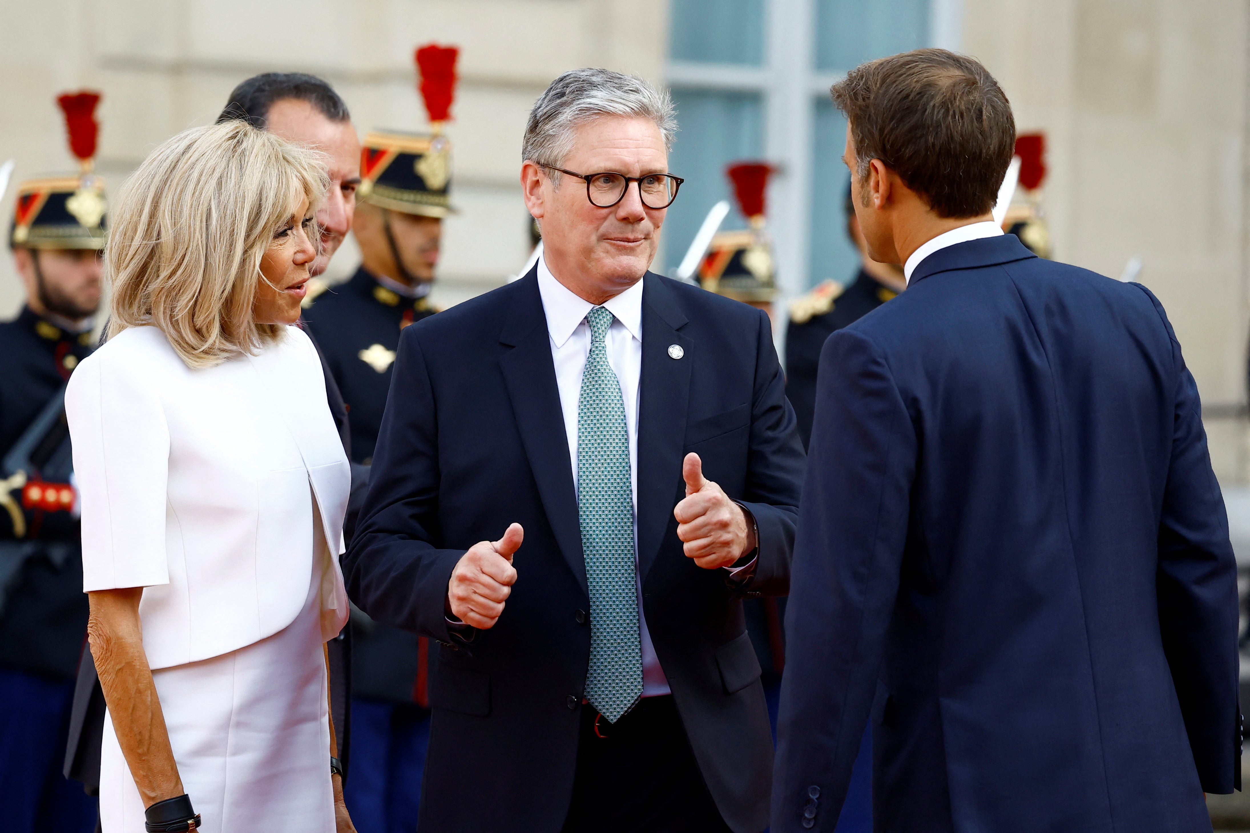 French President Emmanuel Macron and his wife Brigitte Macron welcome Britain's Prime Minister Keir Starmer as he arrives to attend a reception for heads of state and government at the Elysee Palace before the opening ceremony of the Paris 2024 Paralympic Games