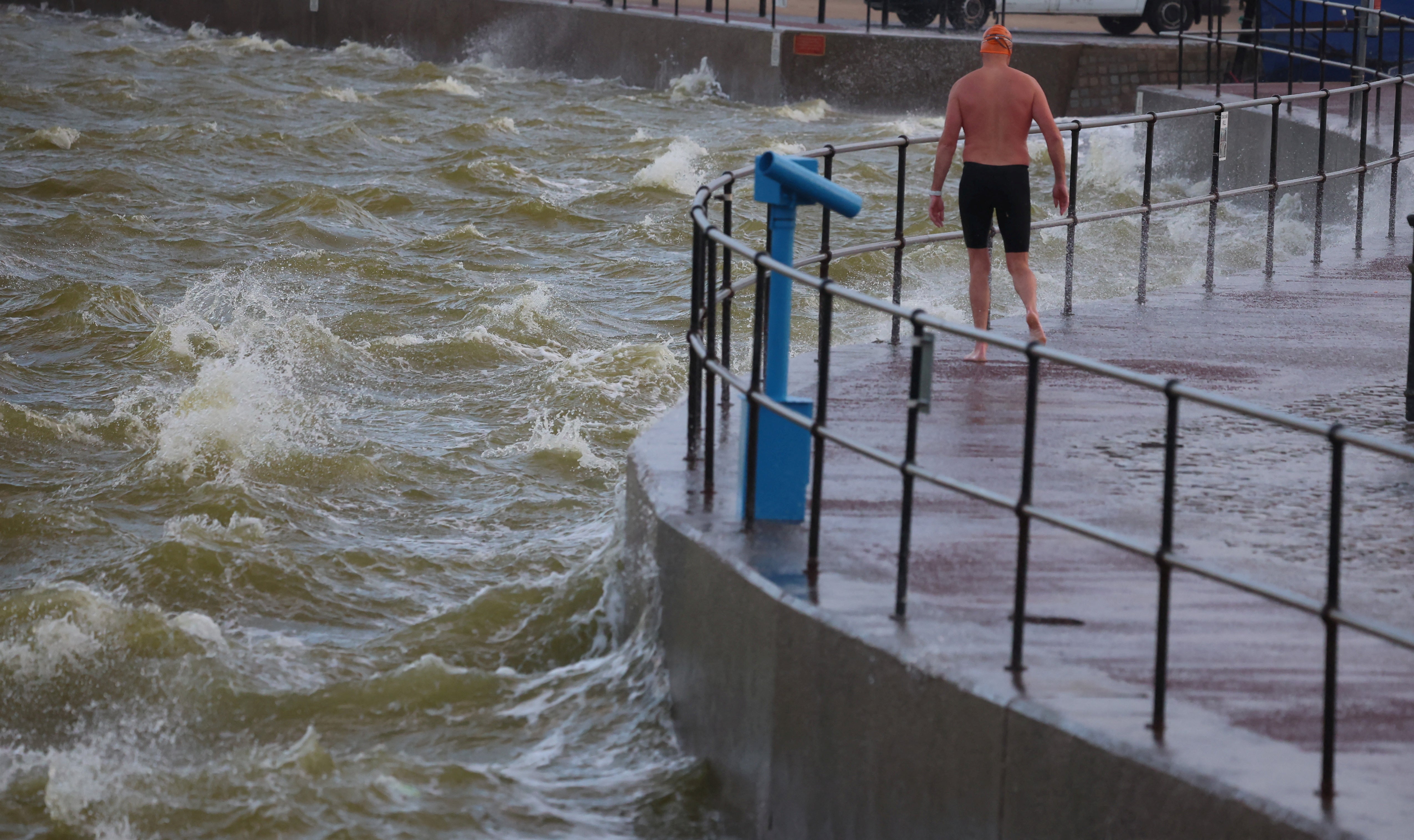 A swimmer braves strong winds and choppy water brought by Storm Lilian in Brighton