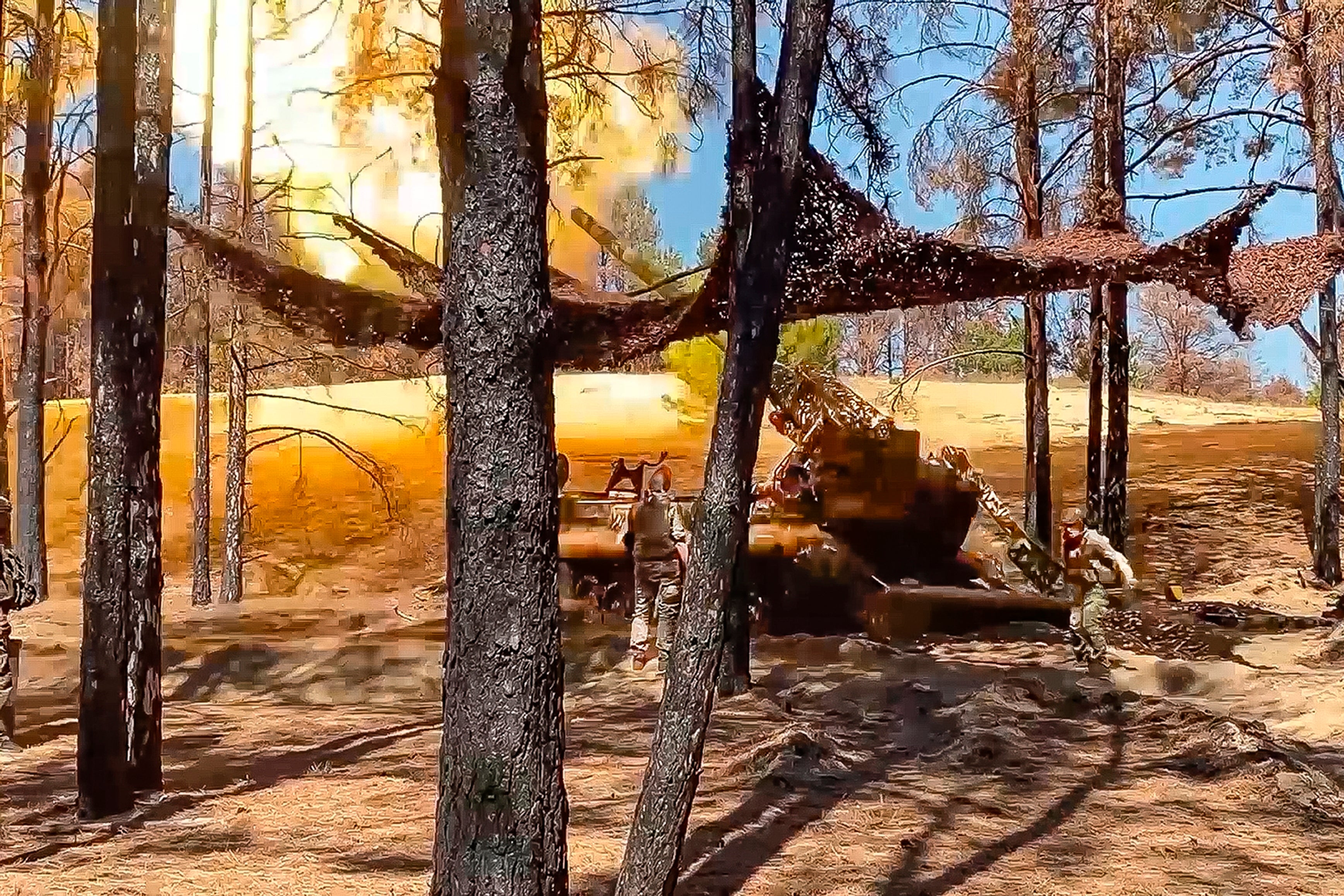 Russian soldiers fires from a 203-mm self-propelled gun 2S7 "Pion" towards Ukrainian positions in an undisclosed location in Ukraine