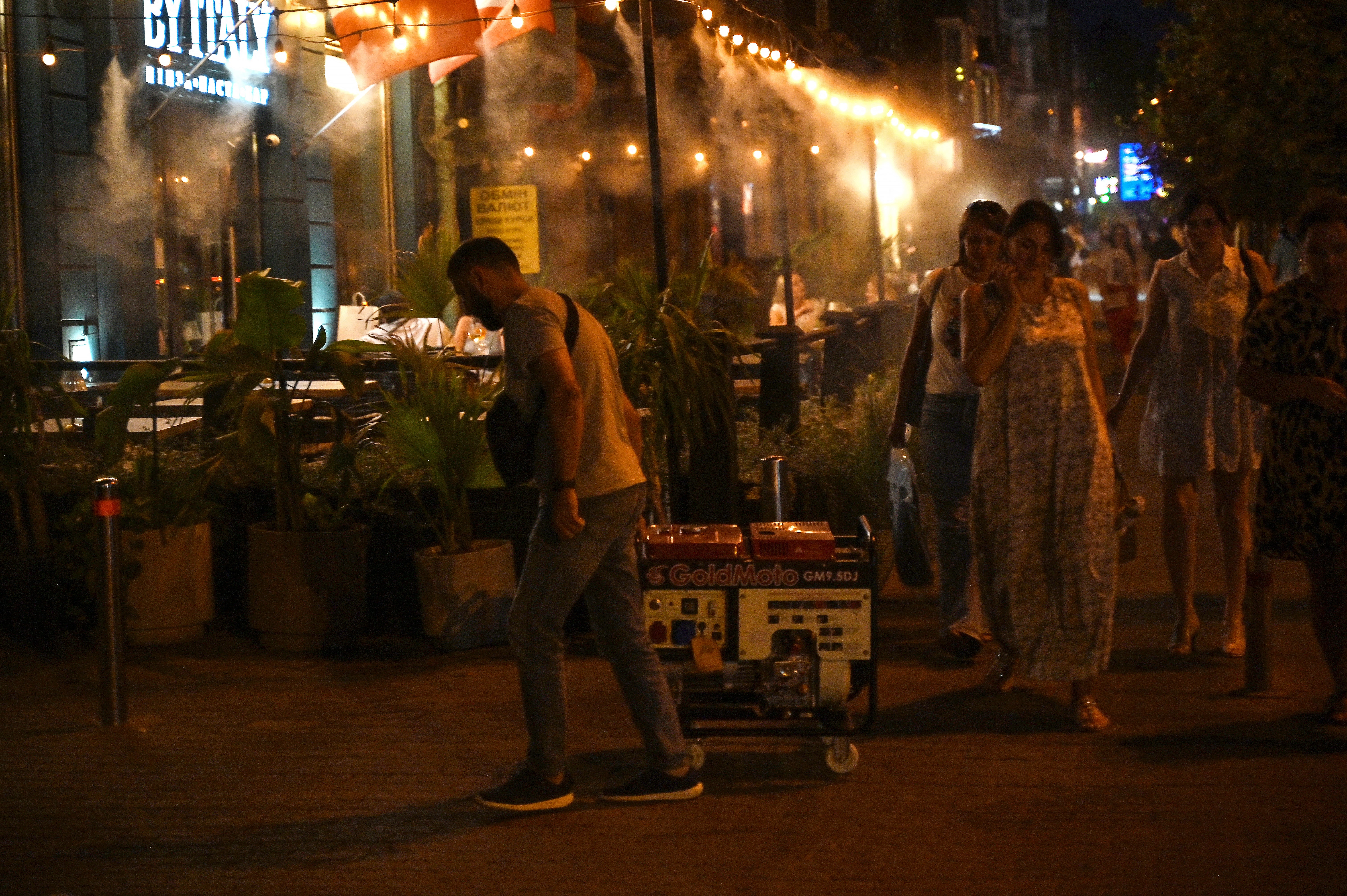 A man carries a power generator in Kyiv on August 28, 2024 during a partial electricity blackout following Russian strikes on Ukrainian energy infrastructure