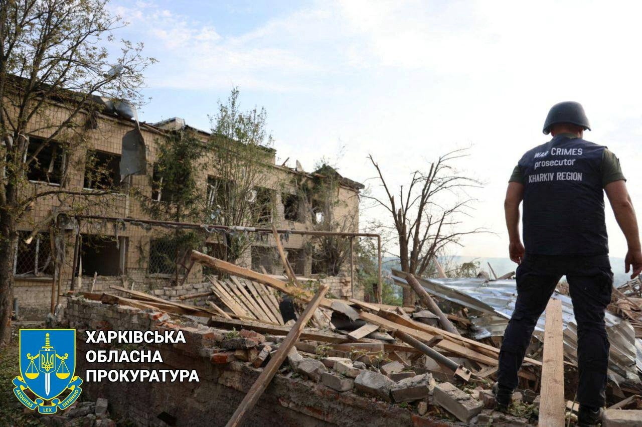 A war crimes prosecutors' personnel looks at the damage in the aftermath of an airstrike in a location given as Kupyansk in Kharkiv Region, Ukraine