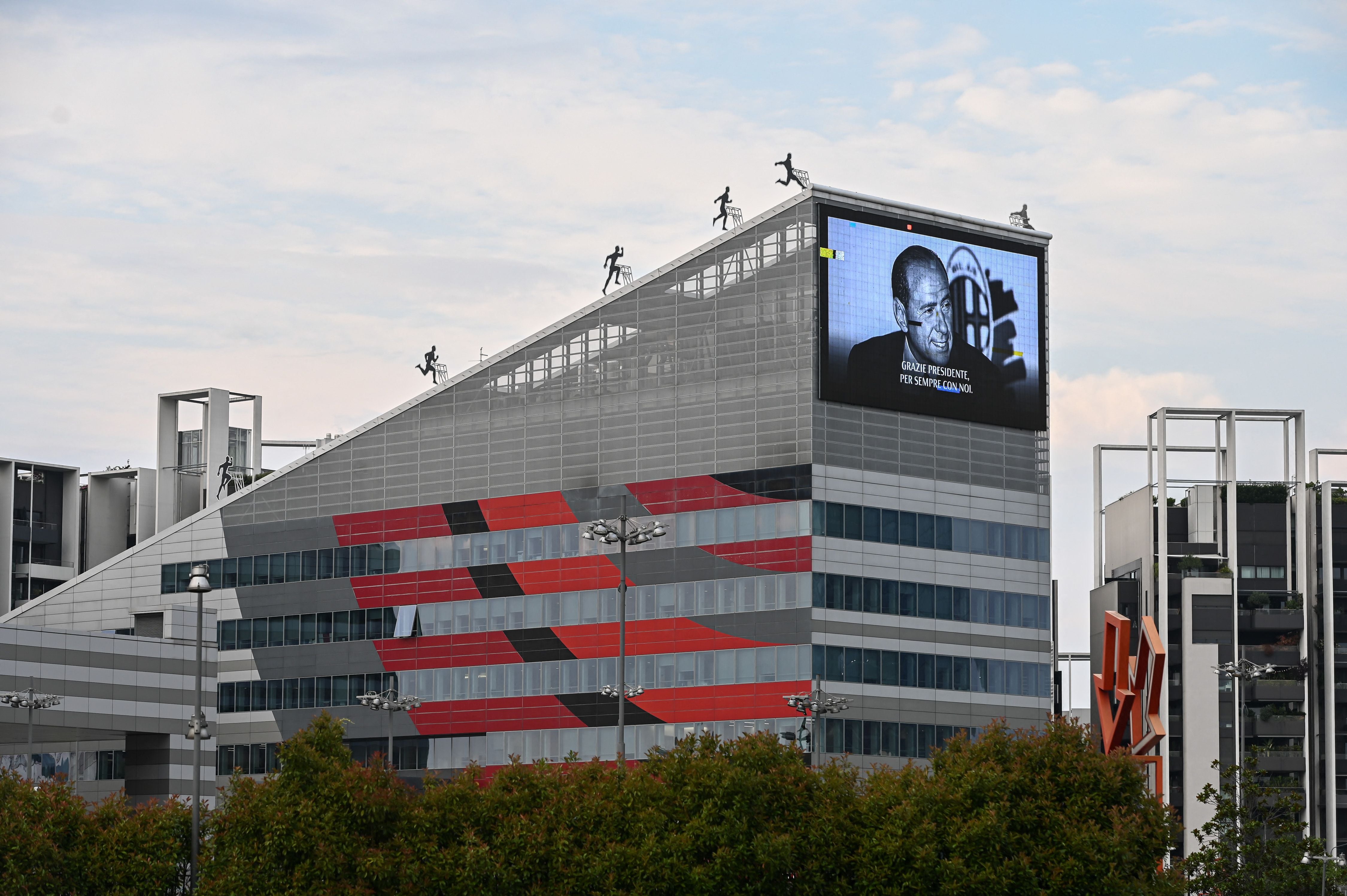 A photo shows a giant screen depicting late Italian businessman and former prime minister Silvio Berlusconi and reading ‘Thank you president, forever with us’