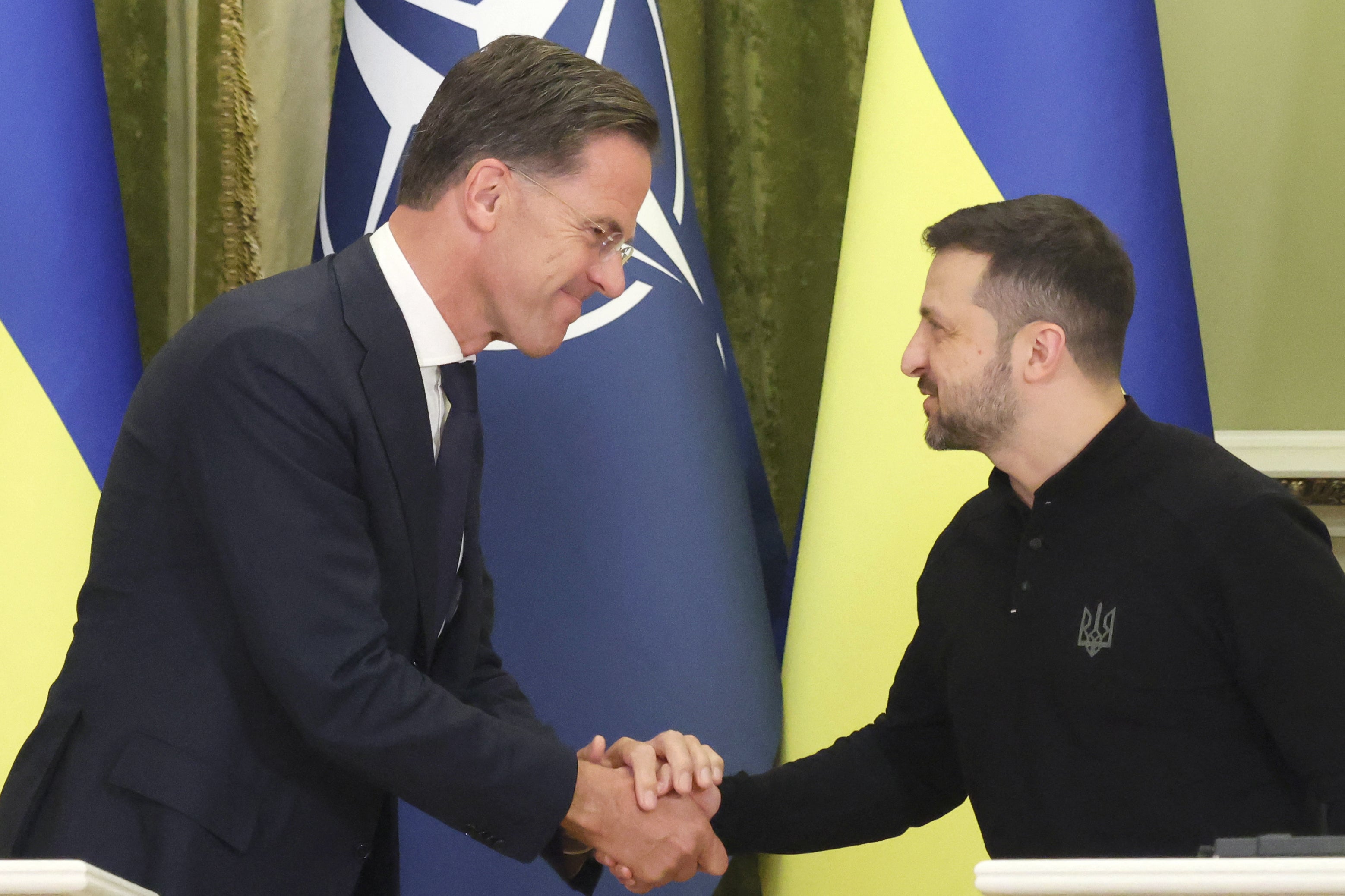 Volodymyr Zelensky and Nato secretary general Mark Rutte shake hands during a joint press conference