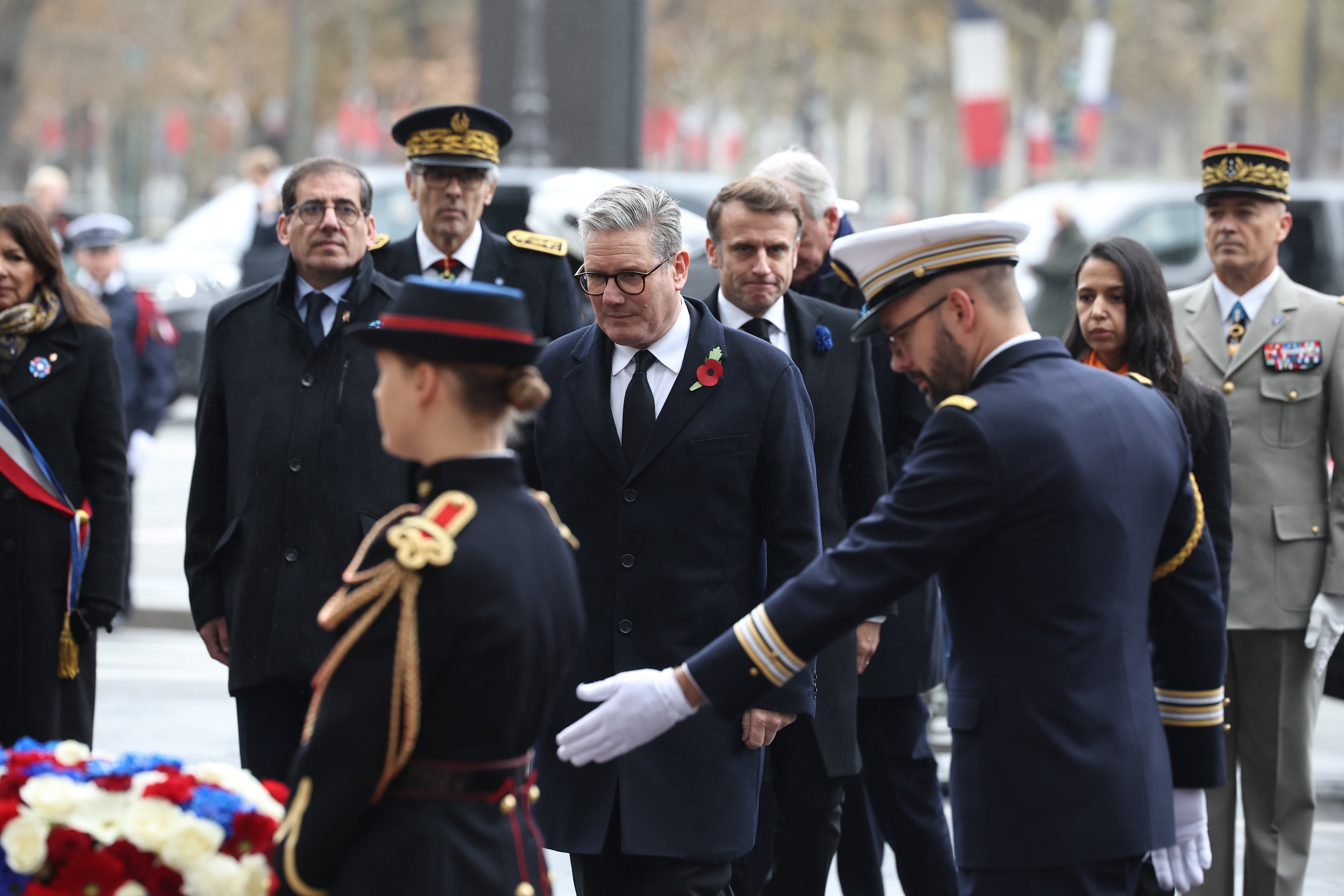 Emmanuel Macron and Keir Starmer attend a wreath-laying ceremony in front of the statue of Georges Clemenceau on the Champs Elysees