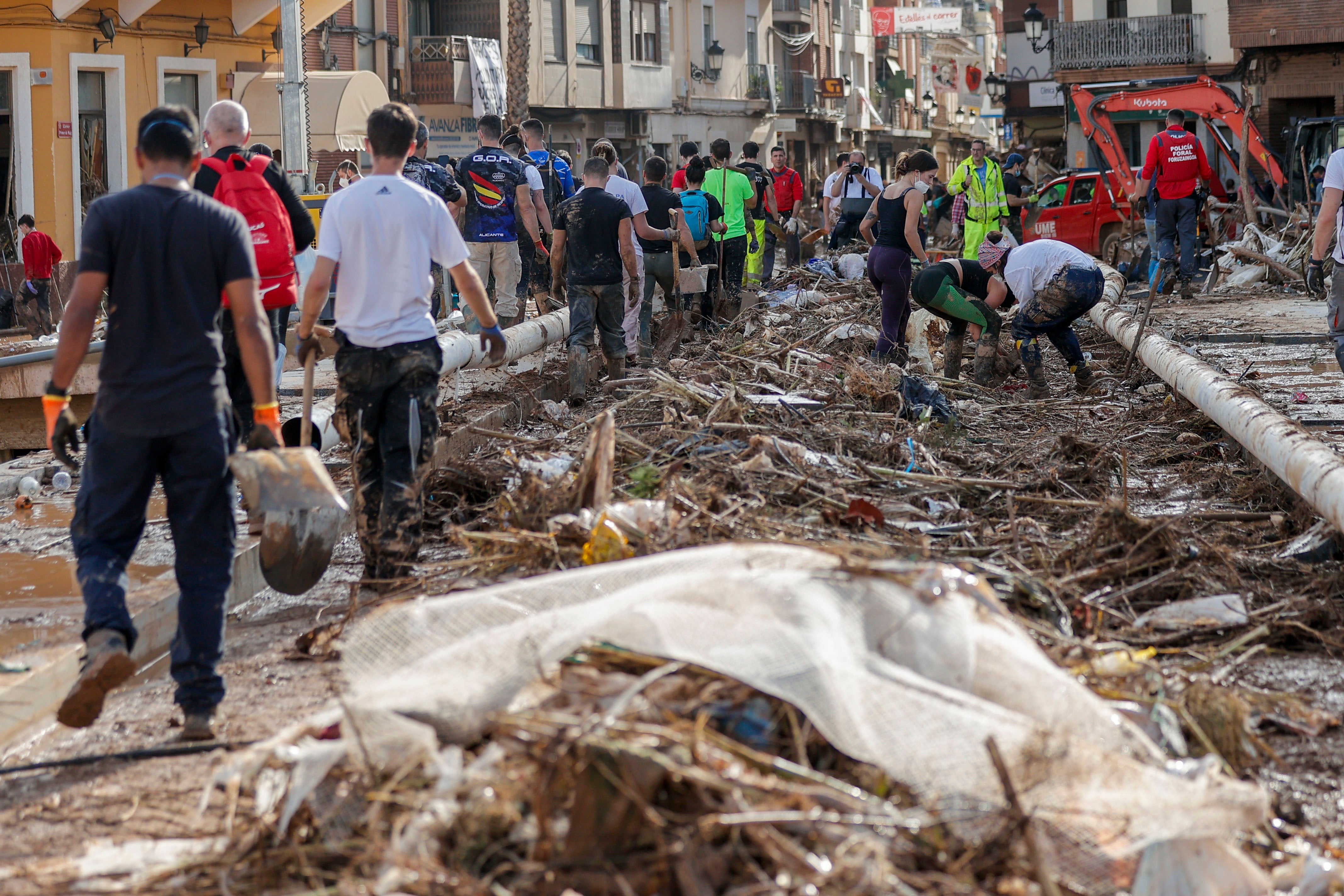 Residents and volunteers carry out clearing duties in the flood-hit municipality of Paiporta, Valencia province, Spain